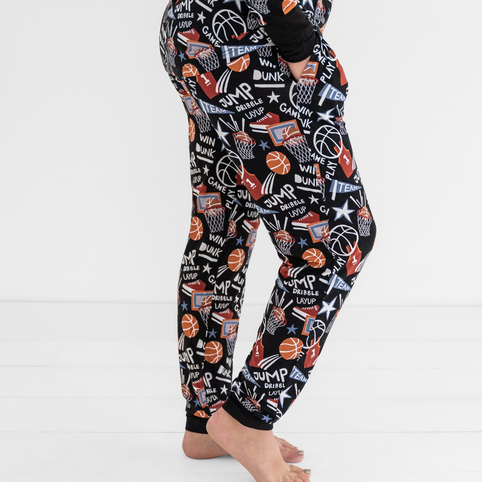 Side view of a woman wearing the Black Slam Dunk bamboo pajama pants