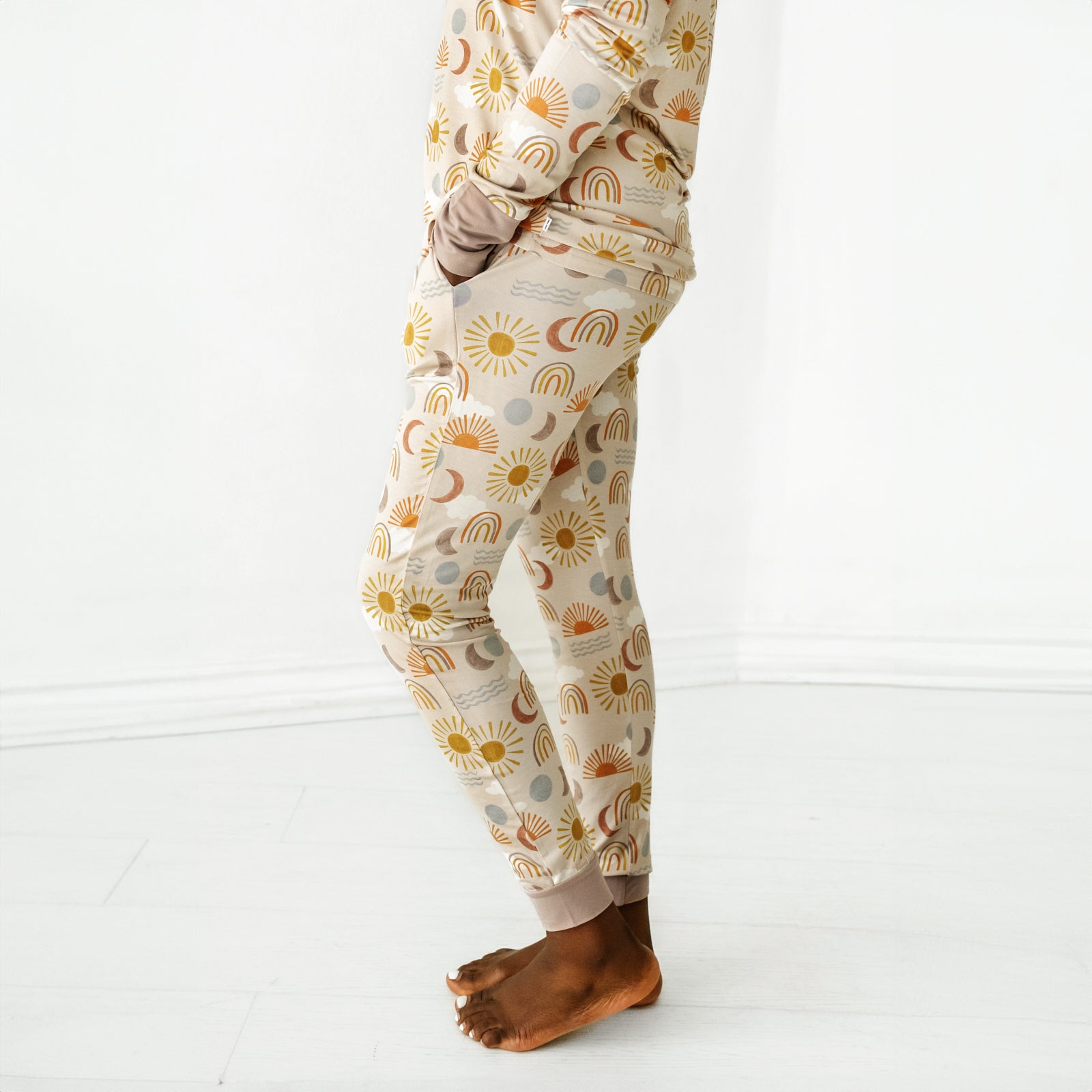 Profile view of a woman wearing Desert Sunrise women's pj pants with her hands in her pockets
