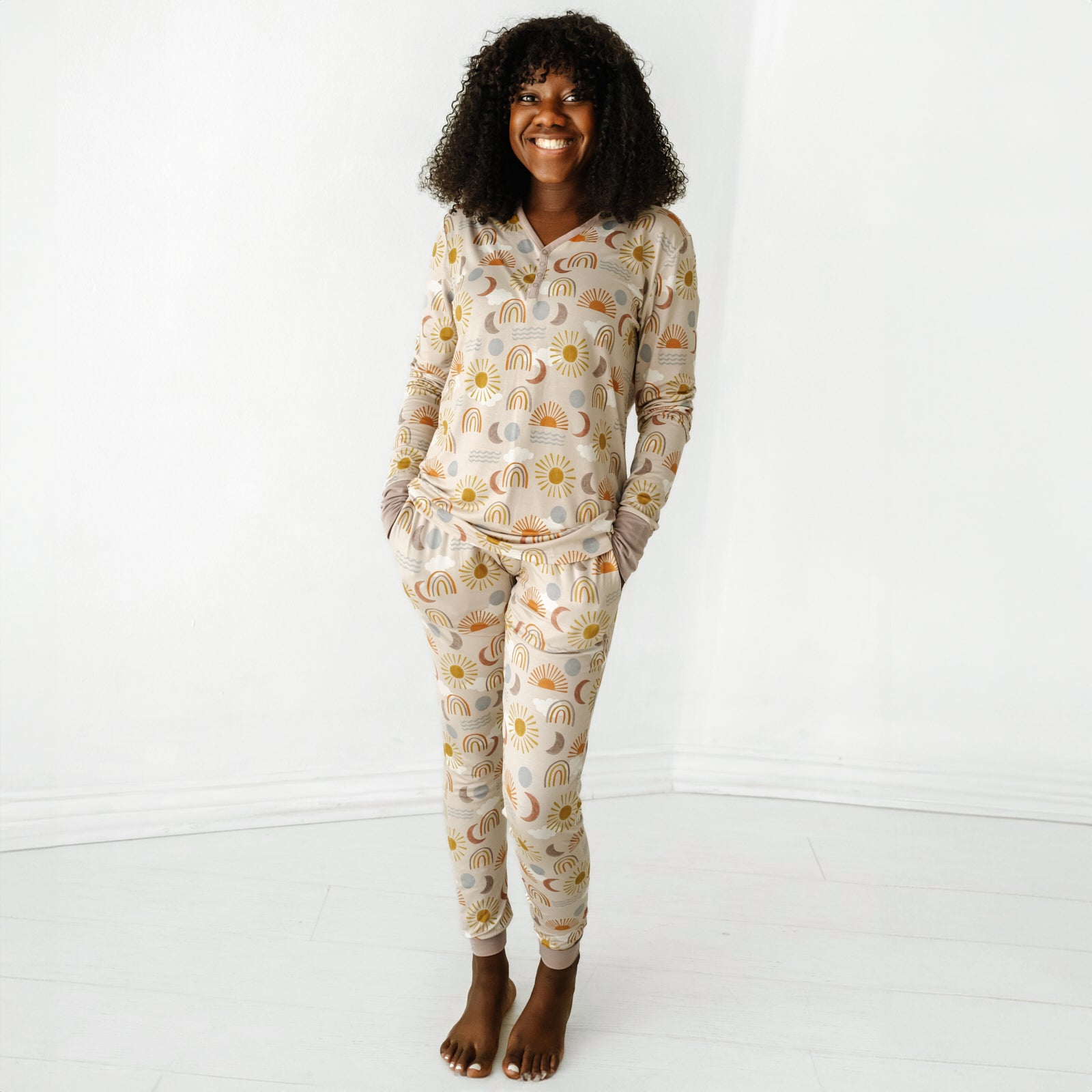 Woman wearing a Desert Sunrise women's pajama top paired with matching women's pajama pants