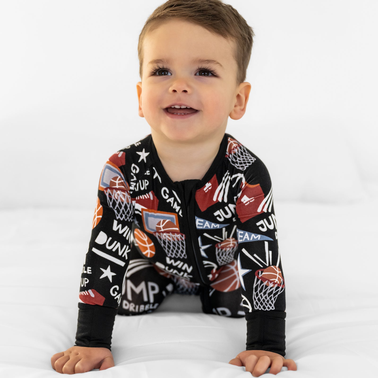 Crawling child wearing the Black Slam Dunk bamboo baby pajamas