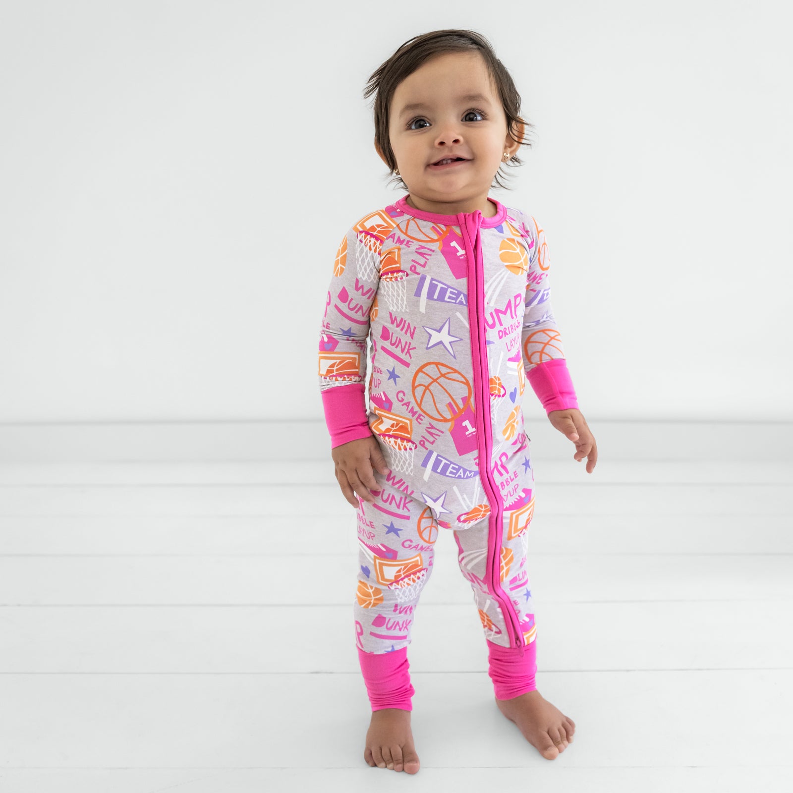 Standing child wearing the Pink Slam Dunk zippy