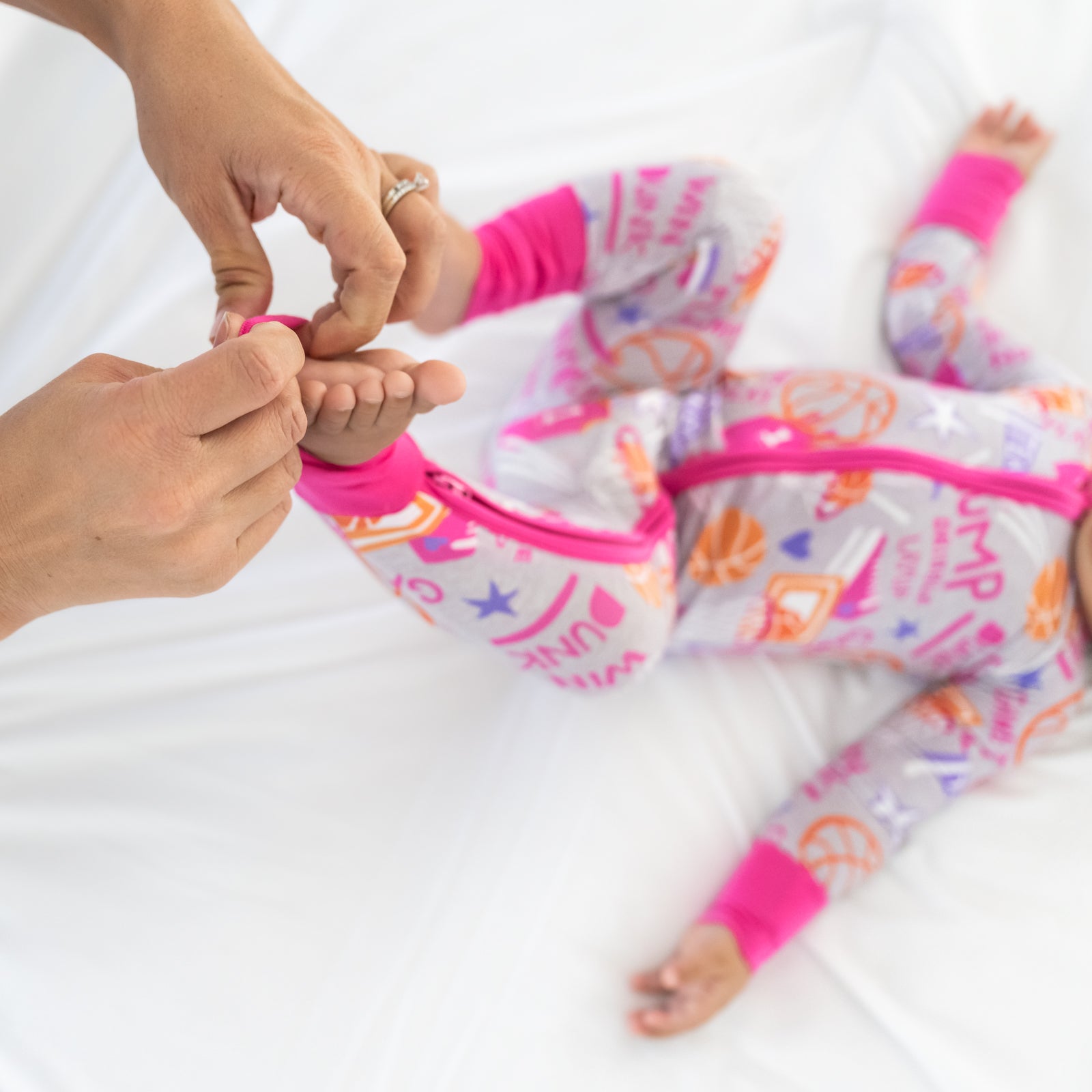 Adult demonstrating the foot fold over feature on the Pink Slam Dunk zippy