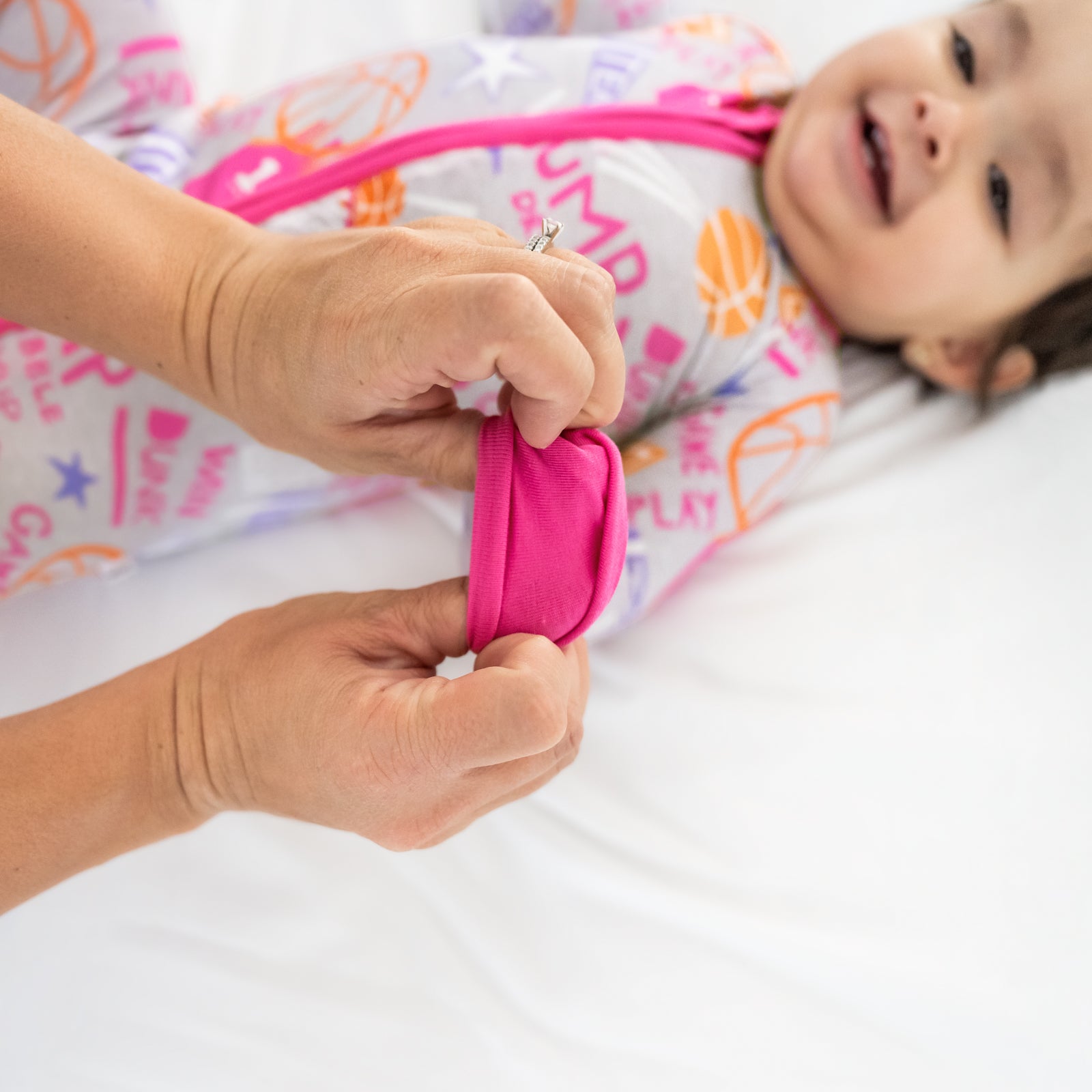 Adult demonstrating the fold over feature on the Pink Slam Dunk zippy