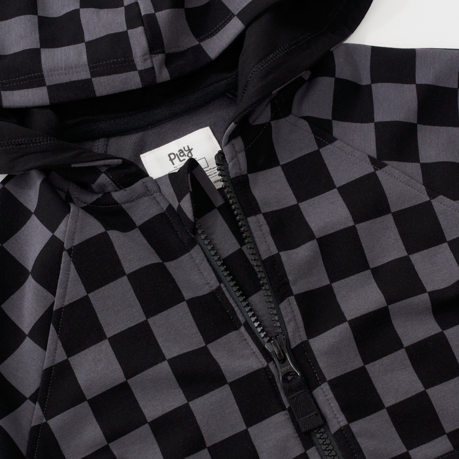 Close up flat lay of the zip detail on the Monochrome Checks Zip Hoodie