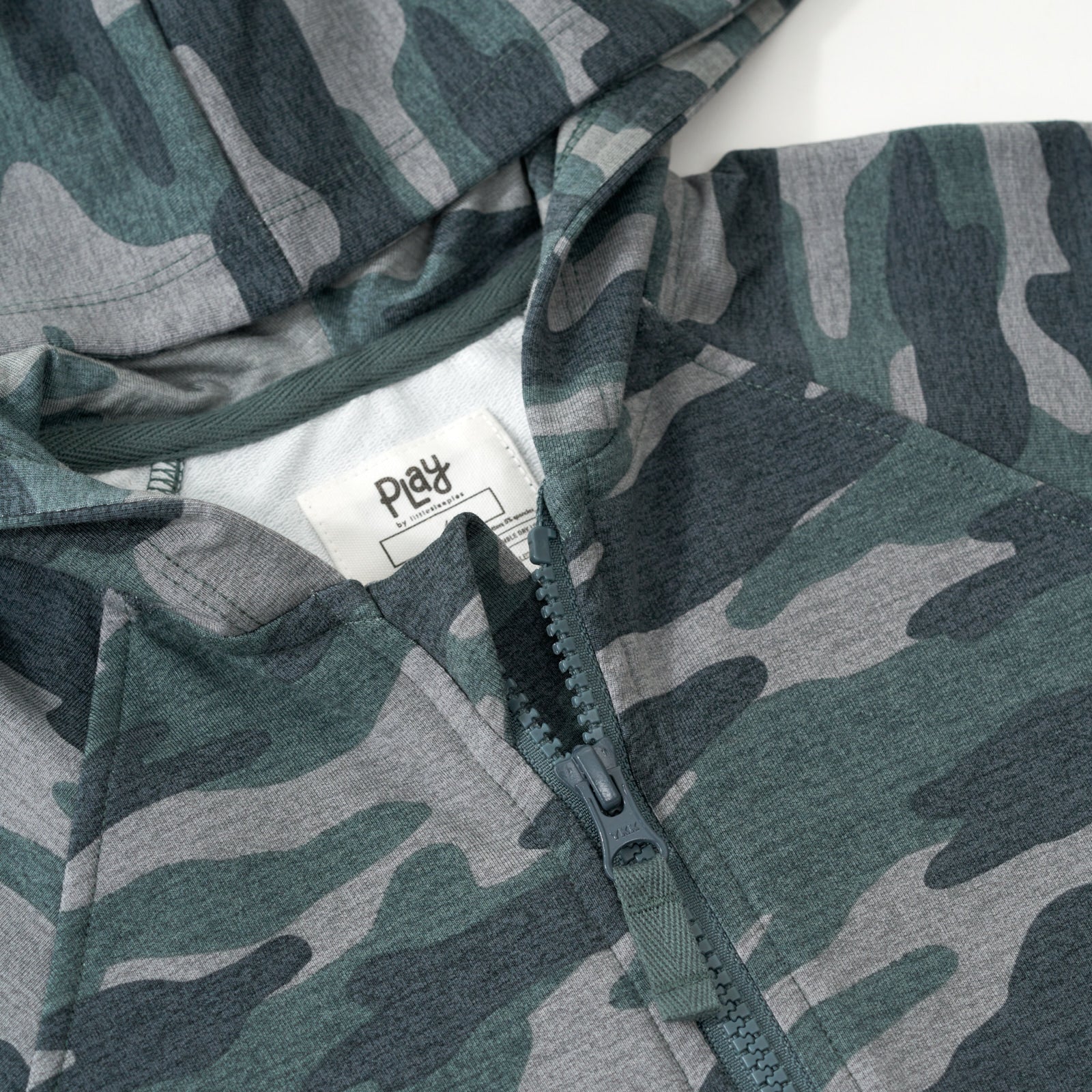 Close up flat lay of the collar and zipper detail on the Vintage Camo Zip Hoodie