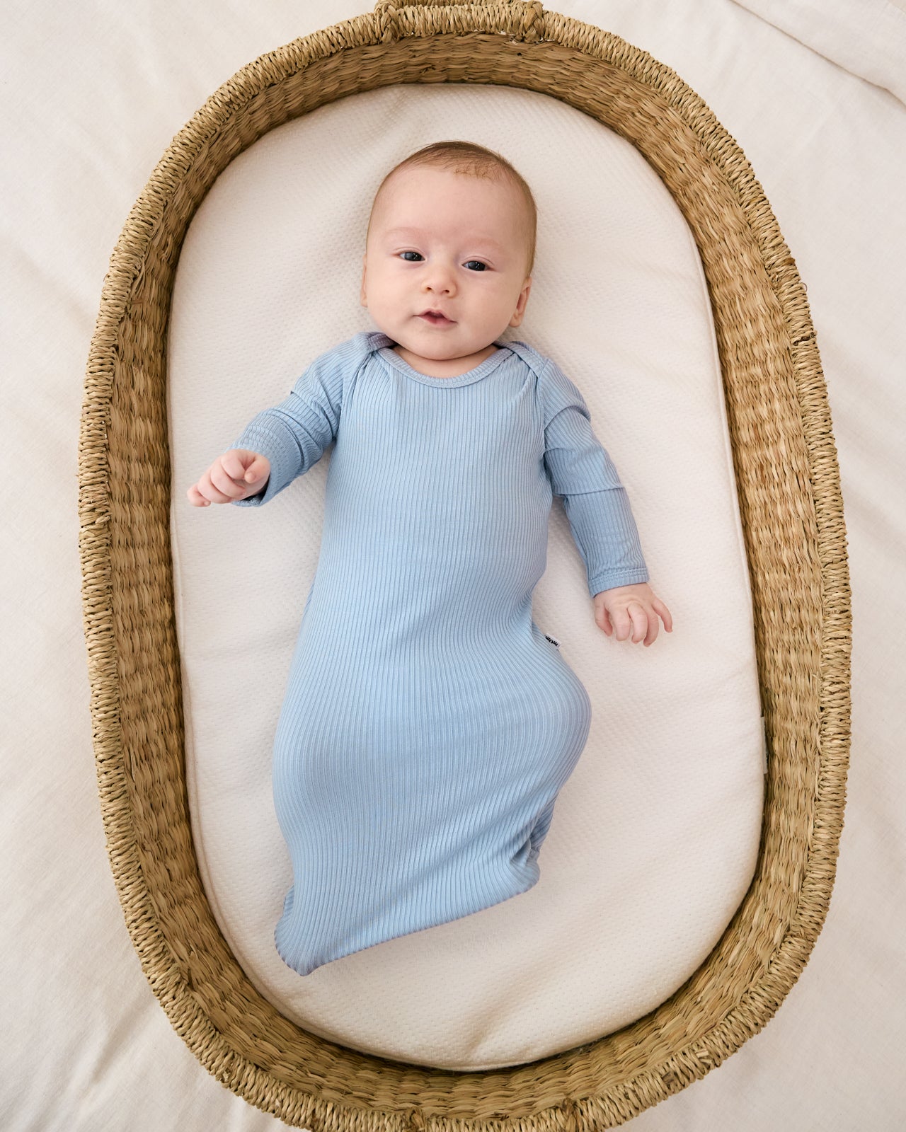 Aerial view of baby wearing the Light Fog Ribbed Infant Gown