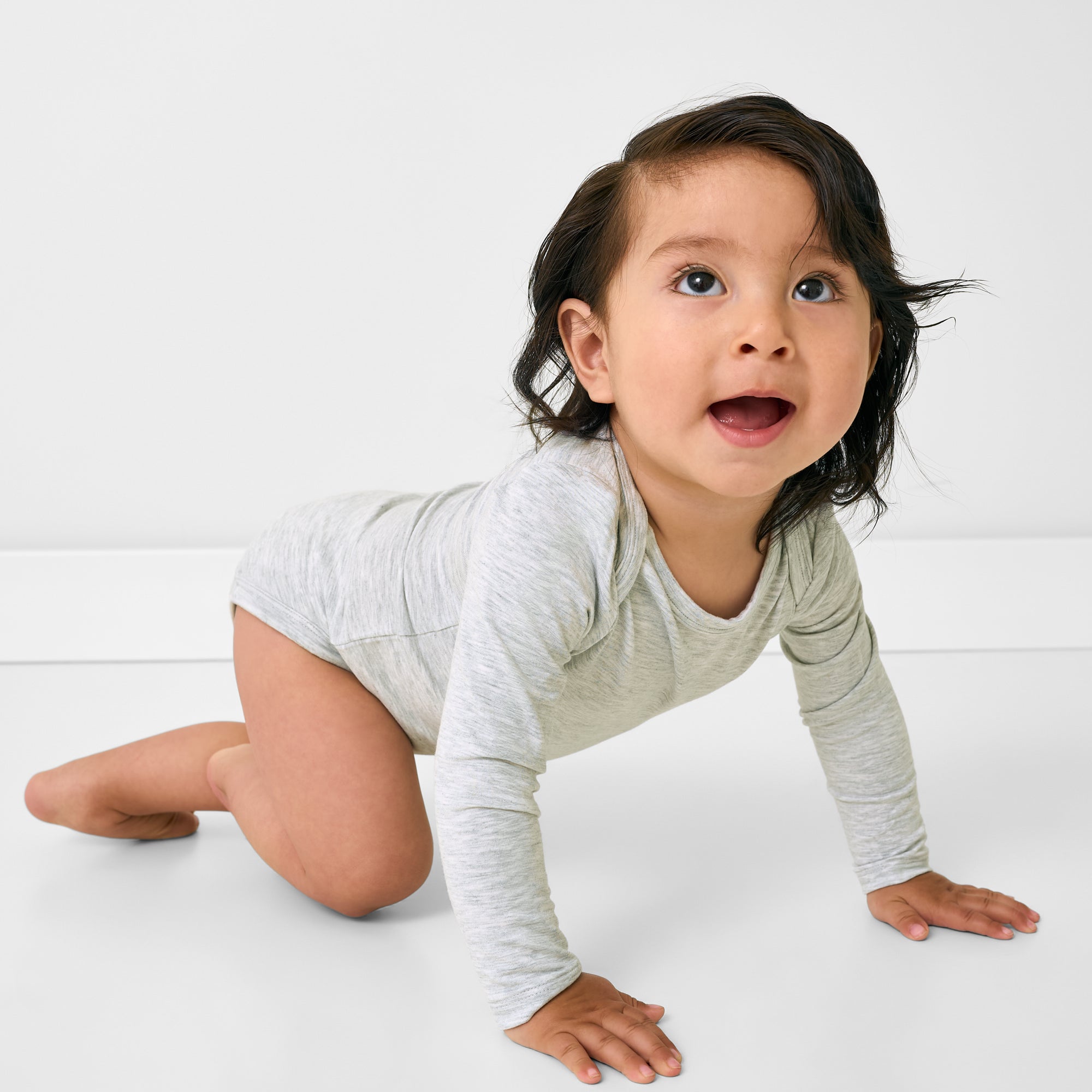Crawling child wearing the Light Heather Gray Long Sleeve Bodysuit