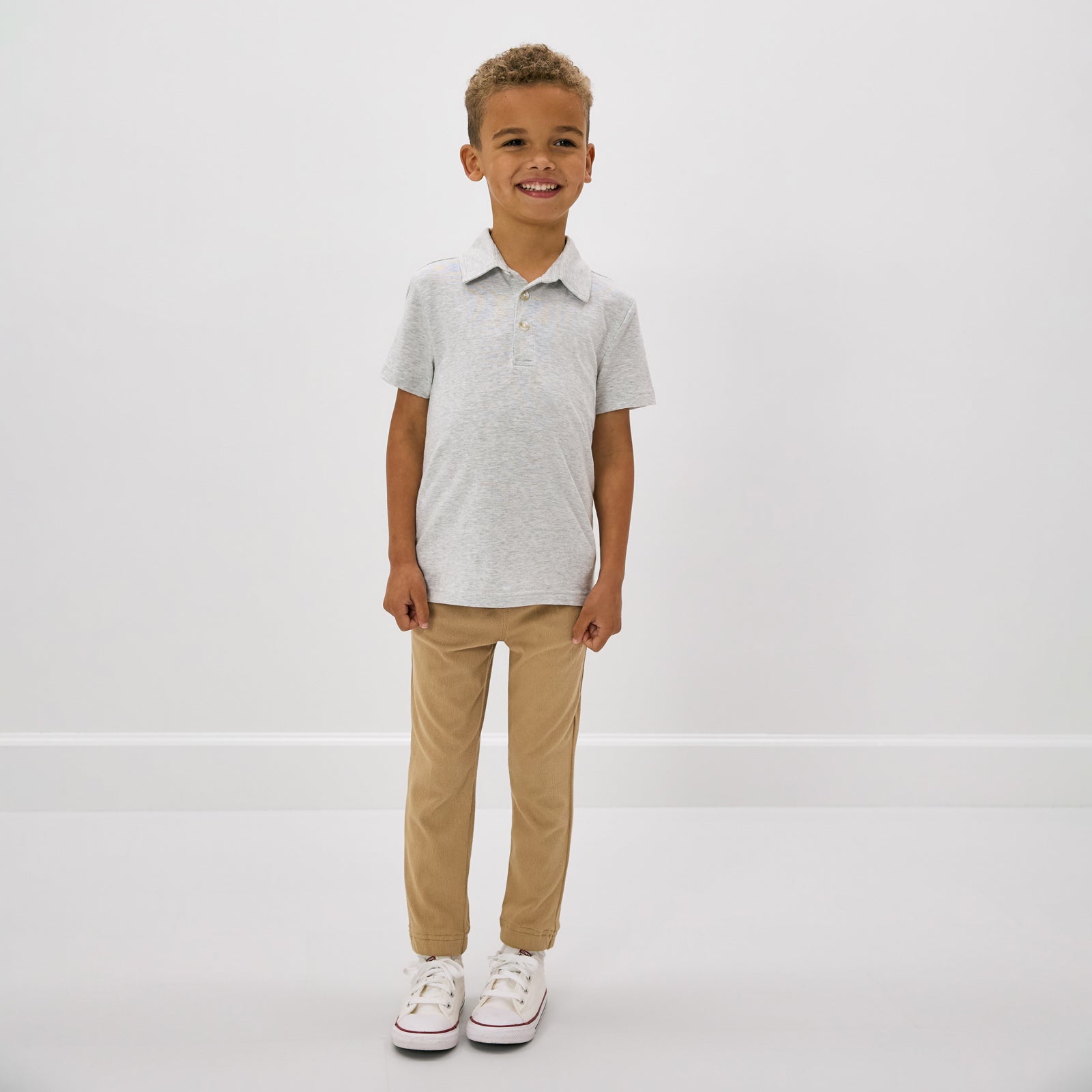 Standing child wearing the Light Heather Gray Polo Shirt with khaki pants