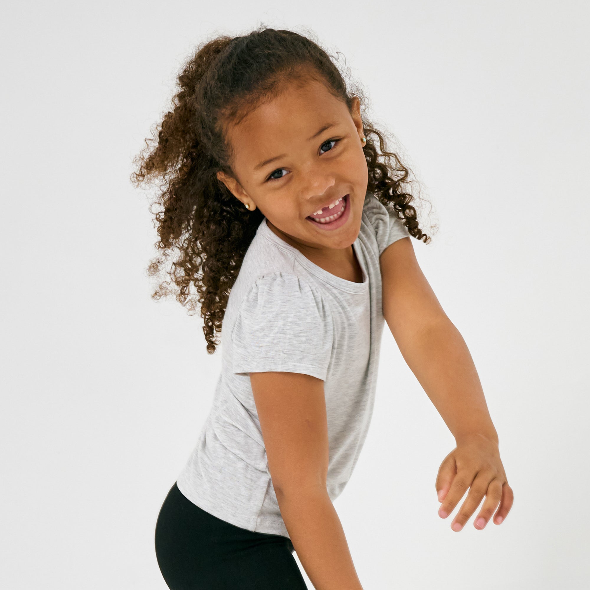 Close up of child in motion wearing the Light Heather Gray Puff Sleeve Tee