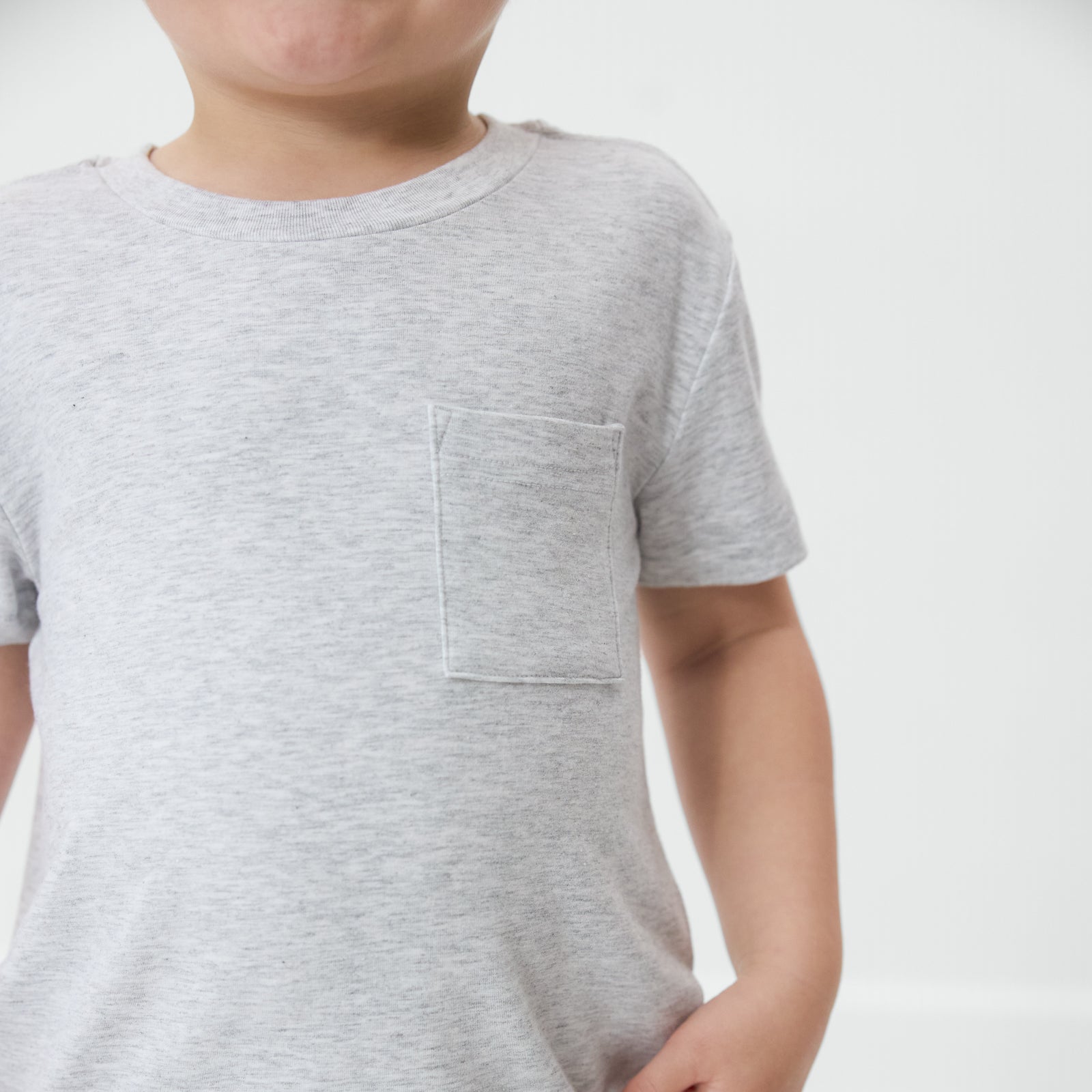 Close up of the pocket detail on the Light Heather Gray Relaxed Pocket Tee