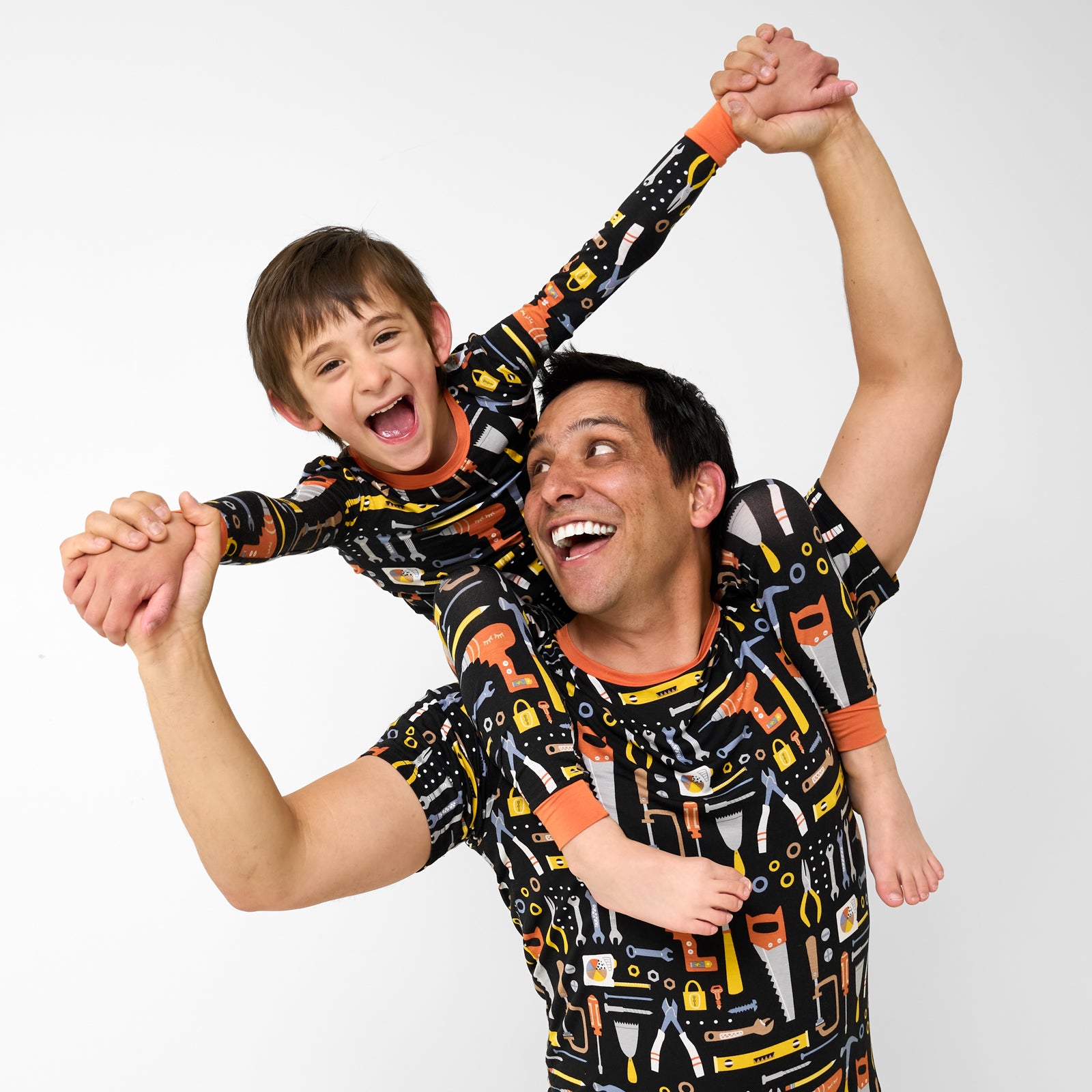 Father and child wearing matching Little Builders bamboo Pajamas