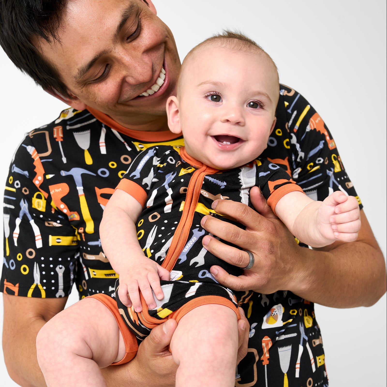 Father and son wearing matching Little Builders pajamas
