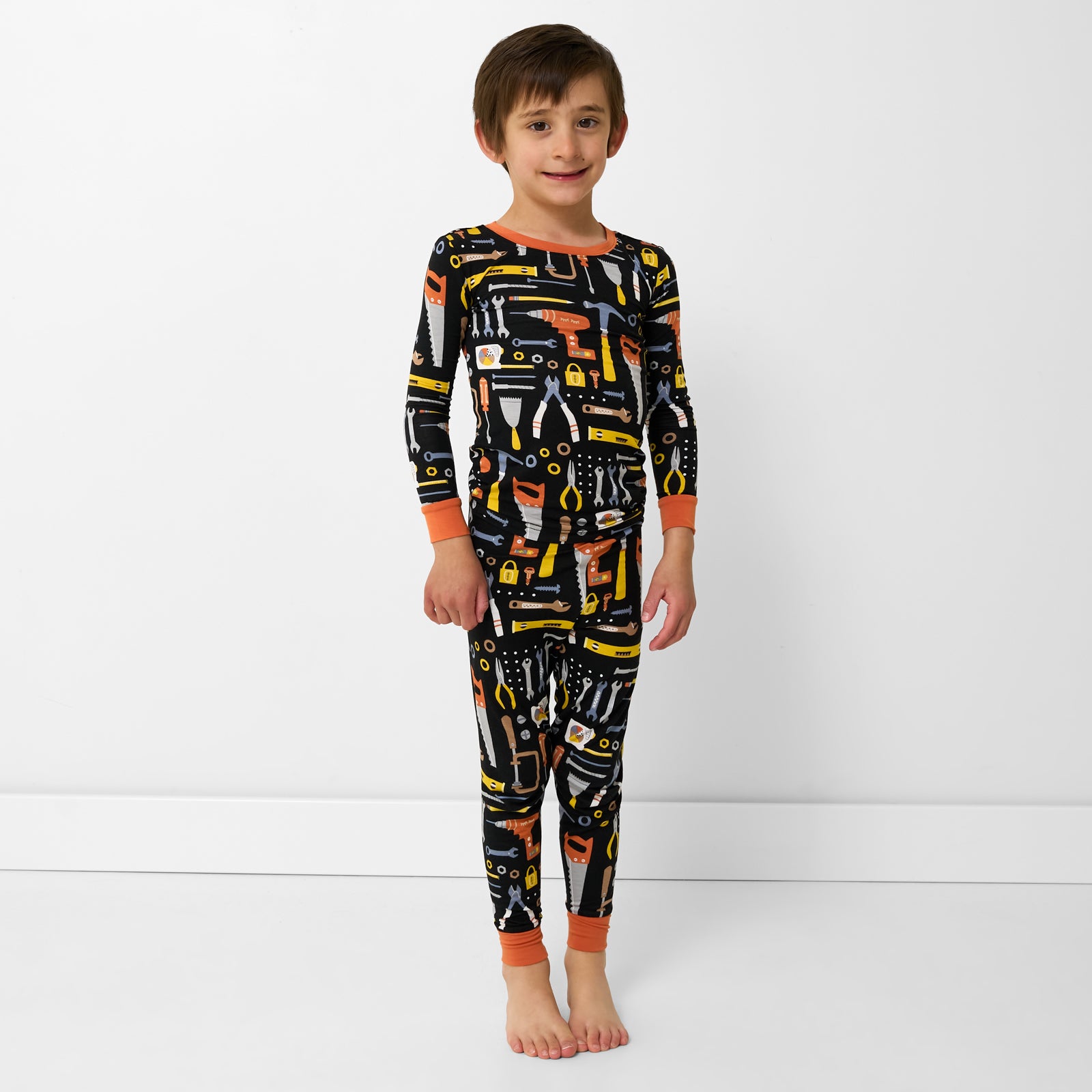 Standing child wearing the Little Builders Two-Piece Pajama Set