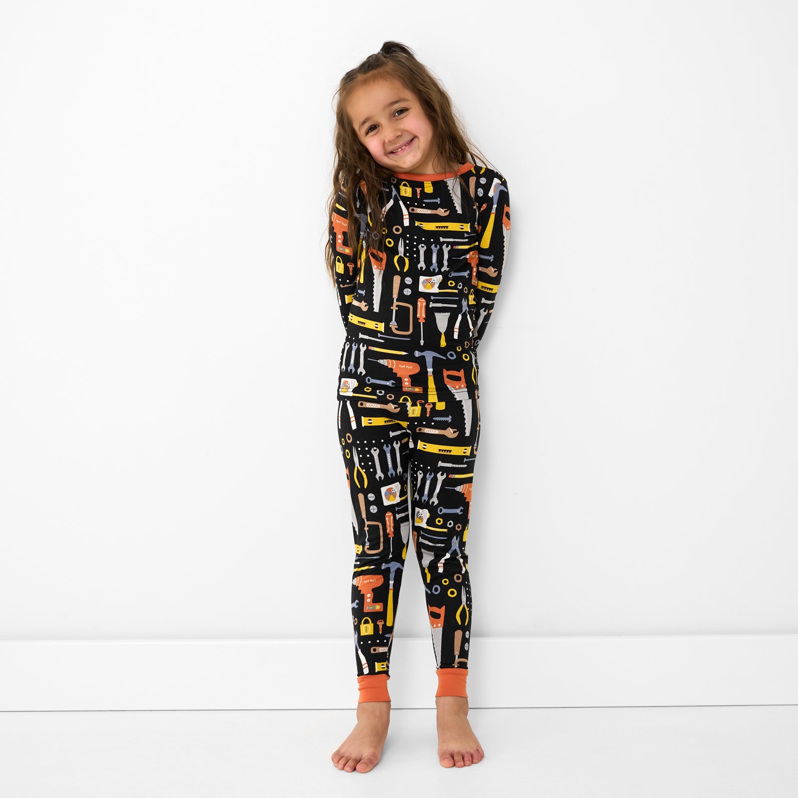 Alternate standing child wearing the Little Builders Two-Piece Bamboo Pajama Set