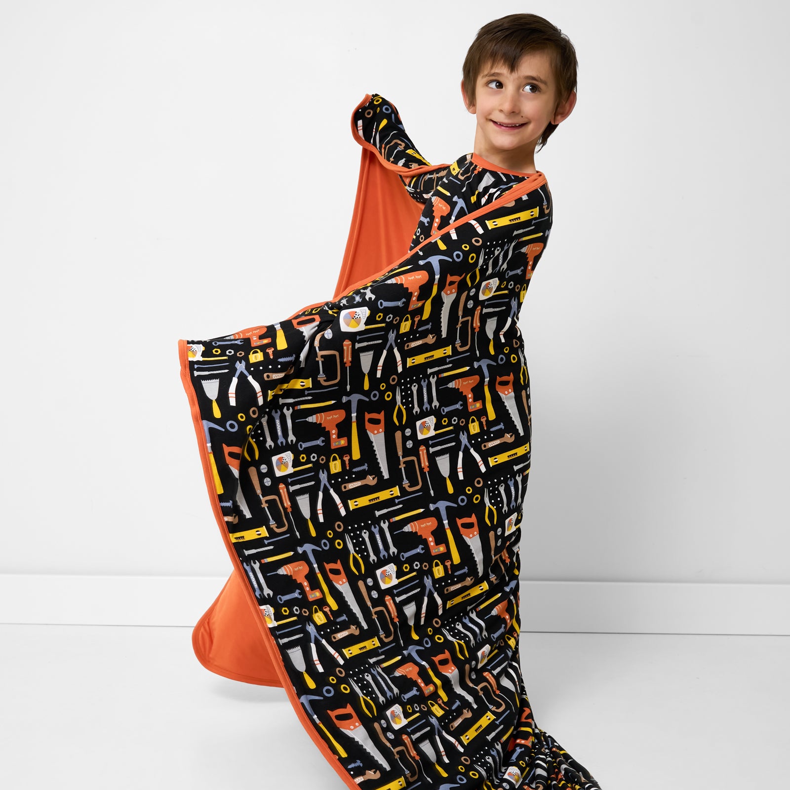 Child twirling with the Little Builders Large Cloud Blanket®