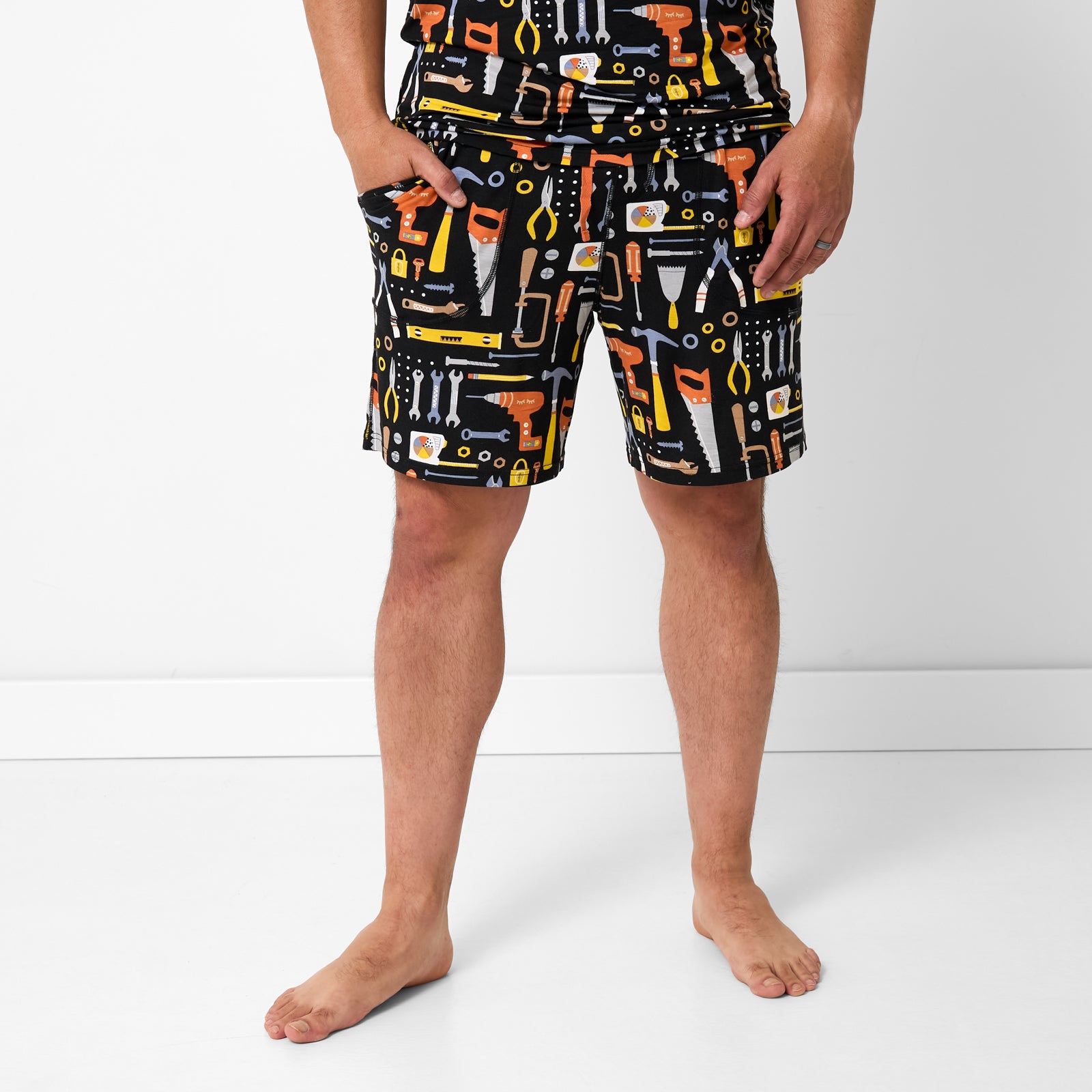 Standing man wearing the Little Builders Men's Pajama Shorts
