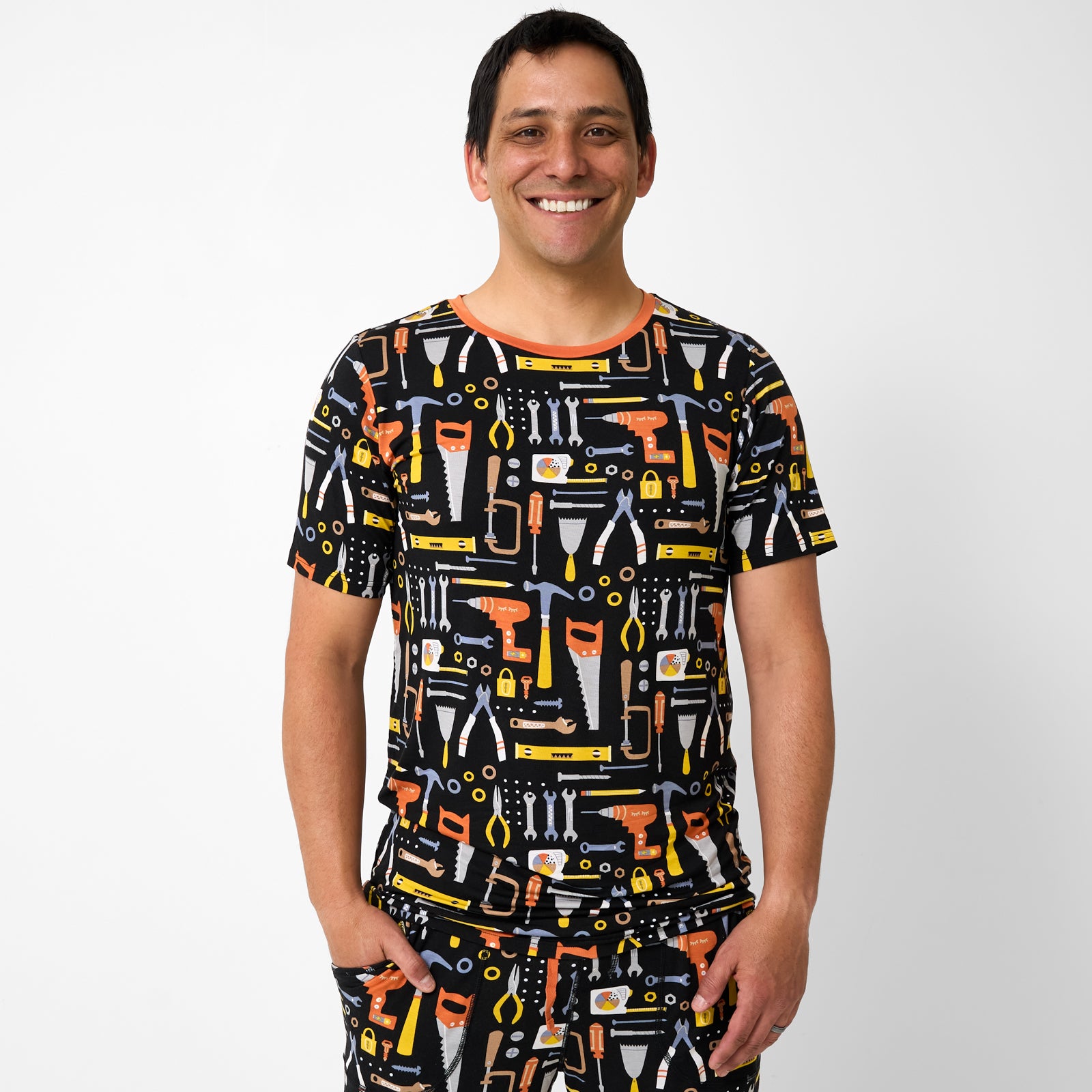 Standing man wearing the Little Builders Men's Short Sleeve Pajama Top