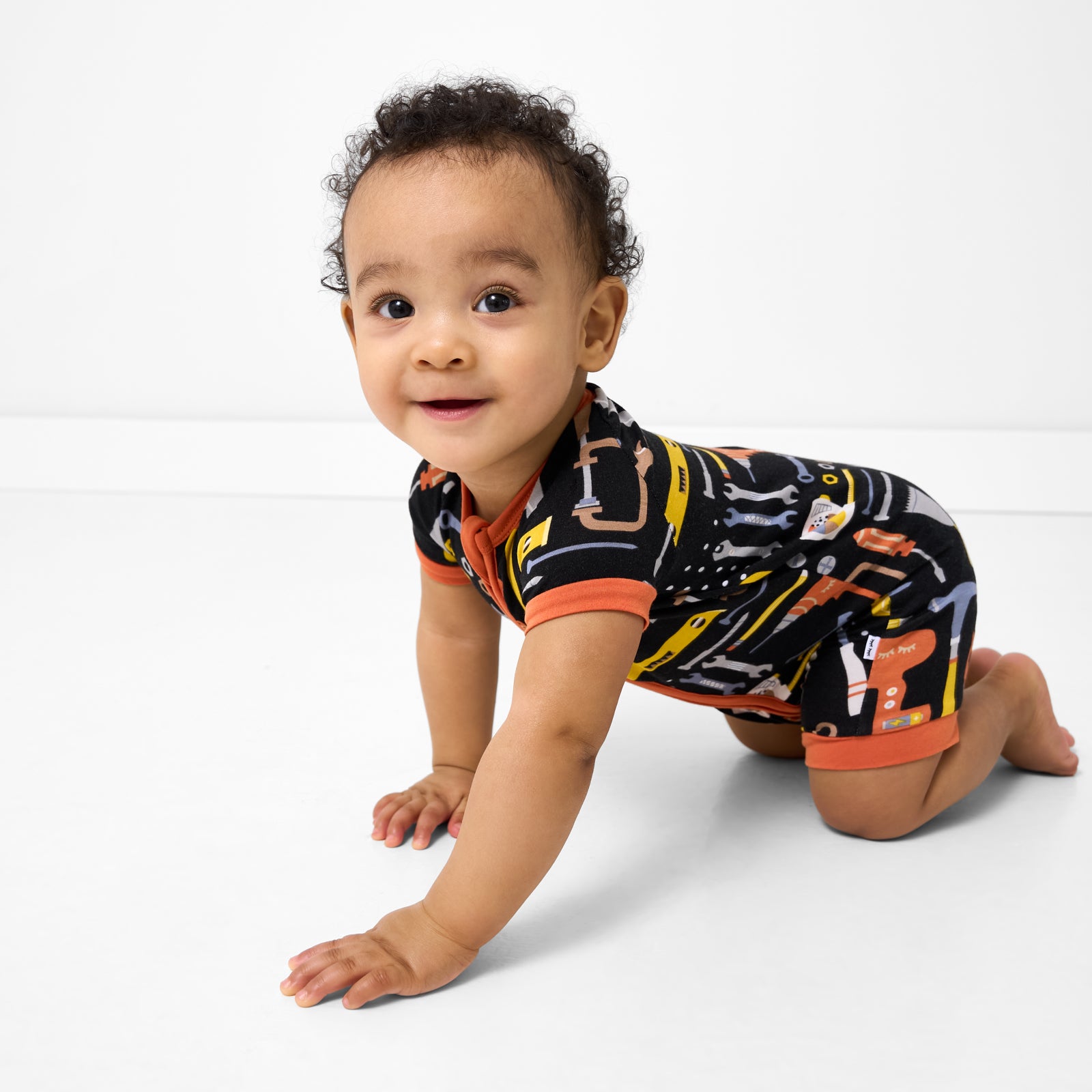 Crawling baby wearing the Little Builders Shorty Zippy