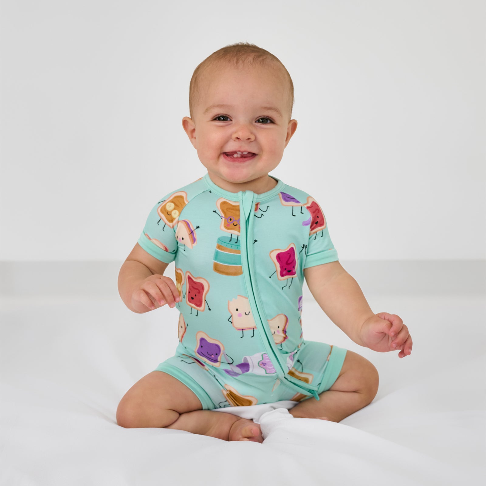 Sitting child wearing the Lunch Buddies Shorty Zippy