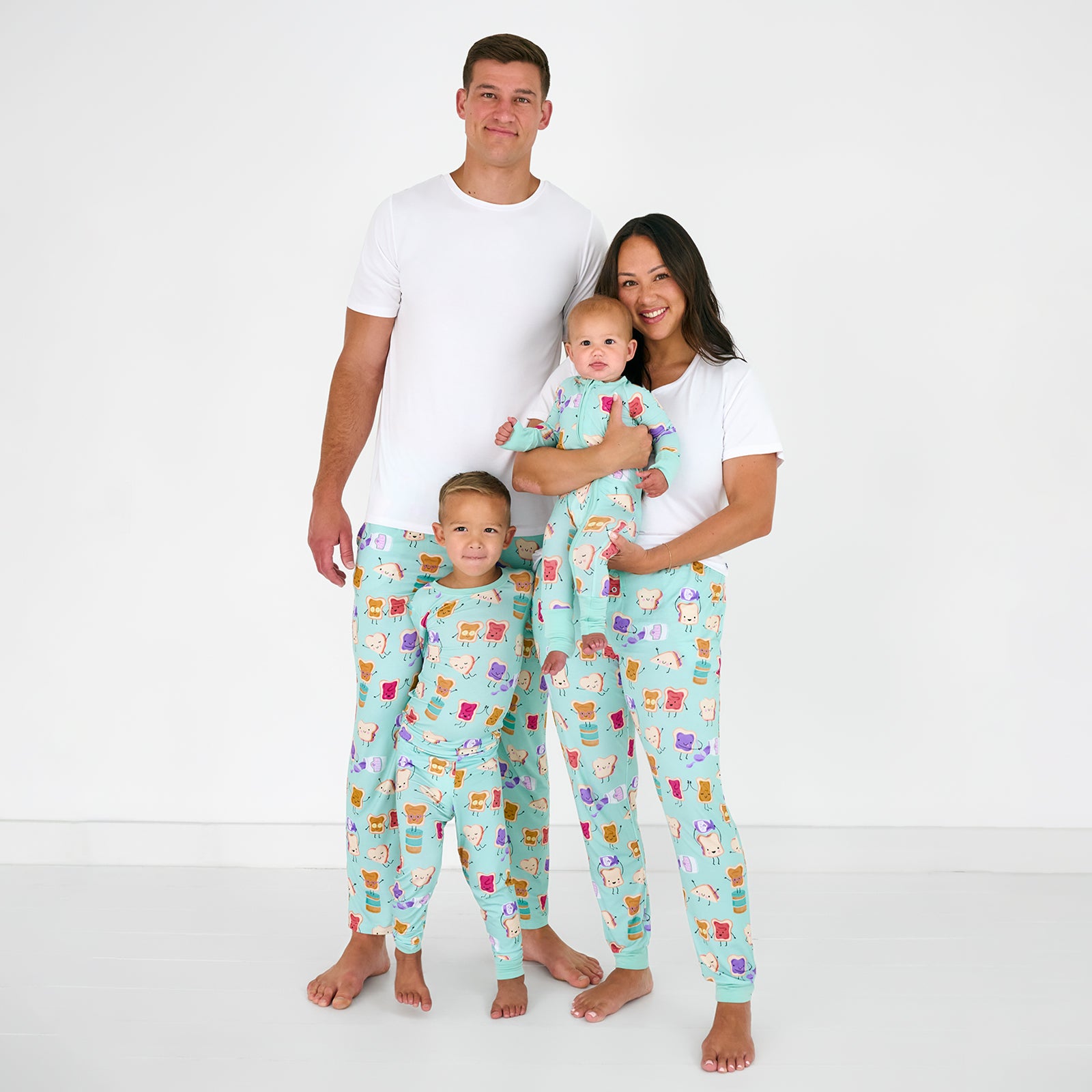 Family of four wearing matching Lunch Buddies bamboo pjs