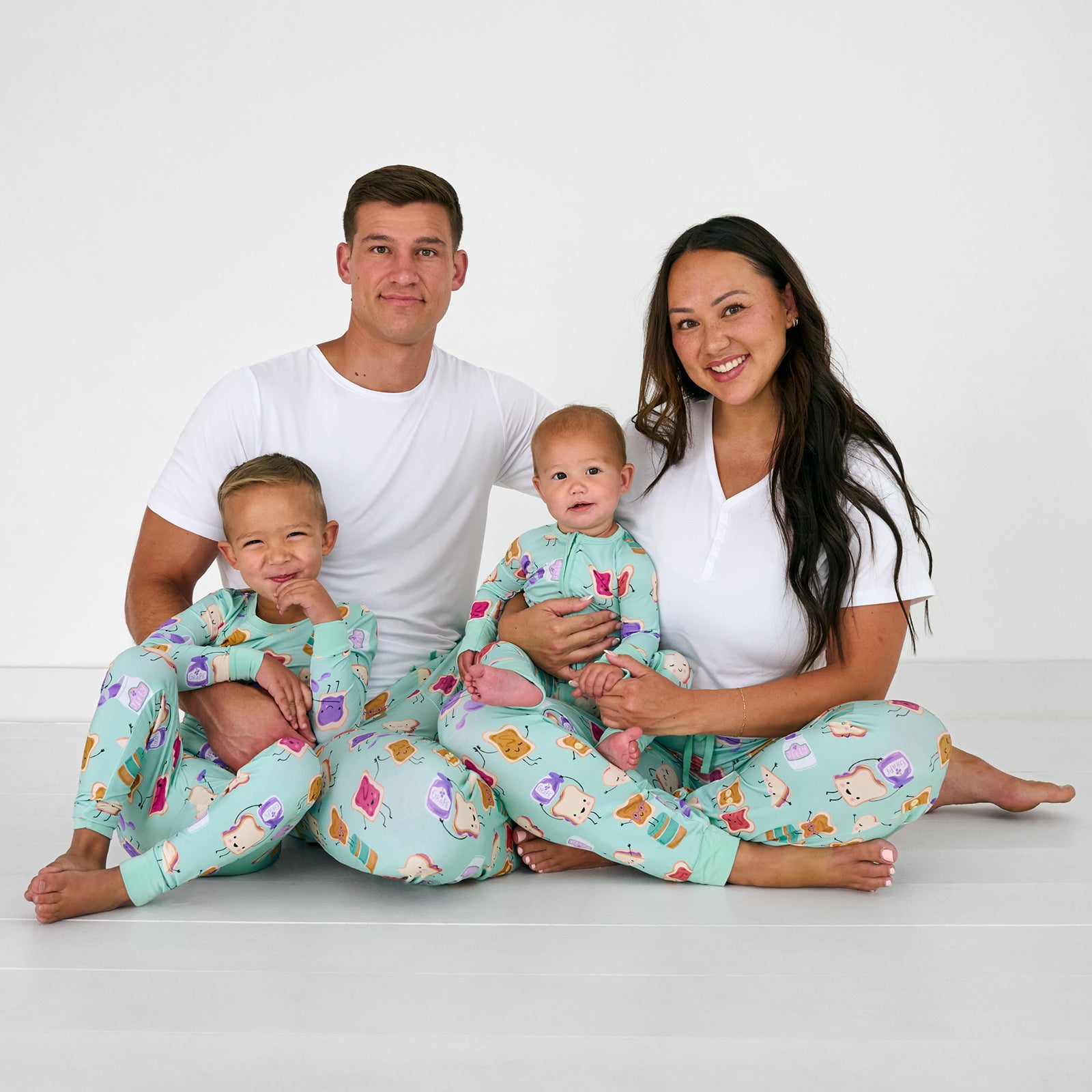 Family of four wearing matching Lunch Buddies bamboo pajamas
