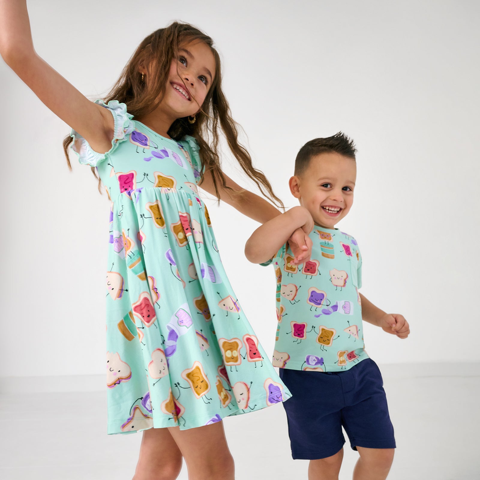 Two children wearing matching Lunch Buddies play styles