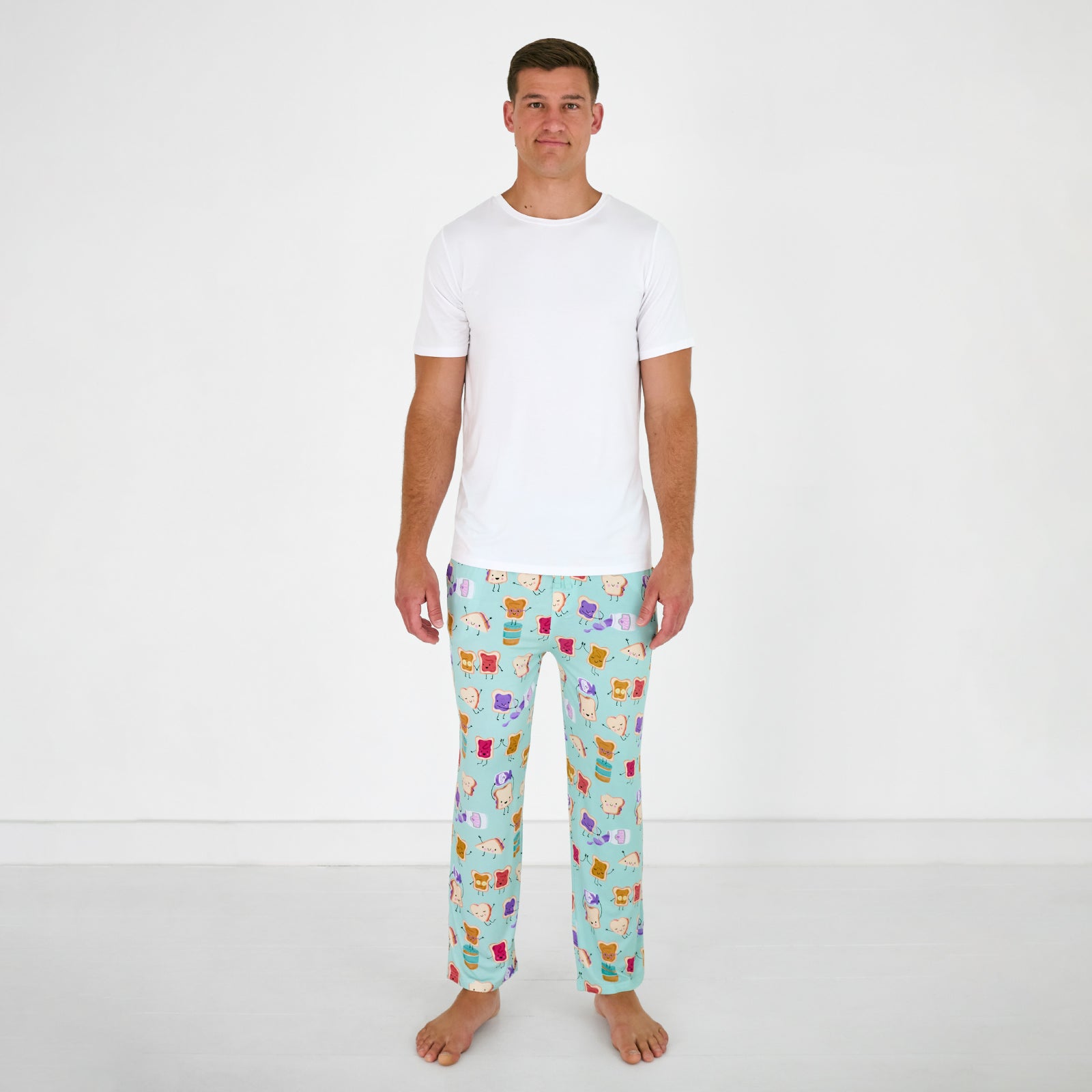 Standing man wearing the Lunch Buddies Men's Pajama Pants with a white ss pj top