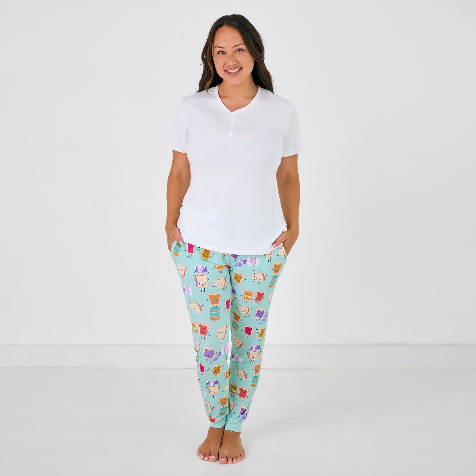 Front view of standing woman wearing the Lunch Buddies Women's Pajama Pants with a white ss pj top