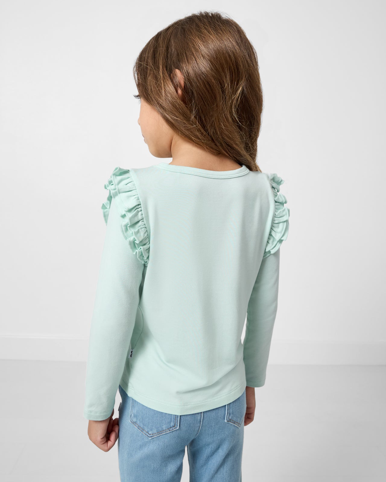 Back view of girl wearing the Mint Mist Flutter Tee