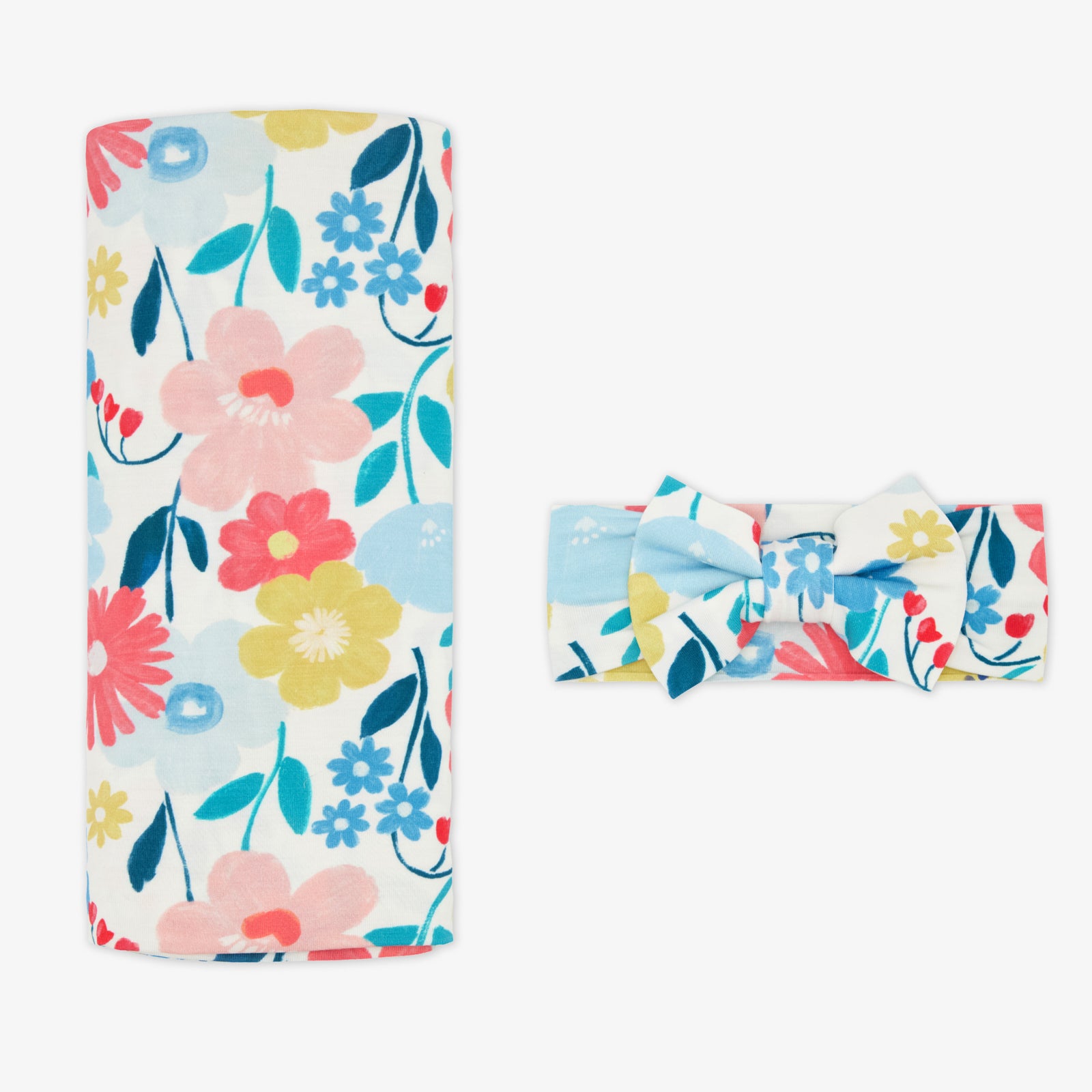 Flat lay of the Midsummer Meadow Swaddle & Luxe Bow Headband Set