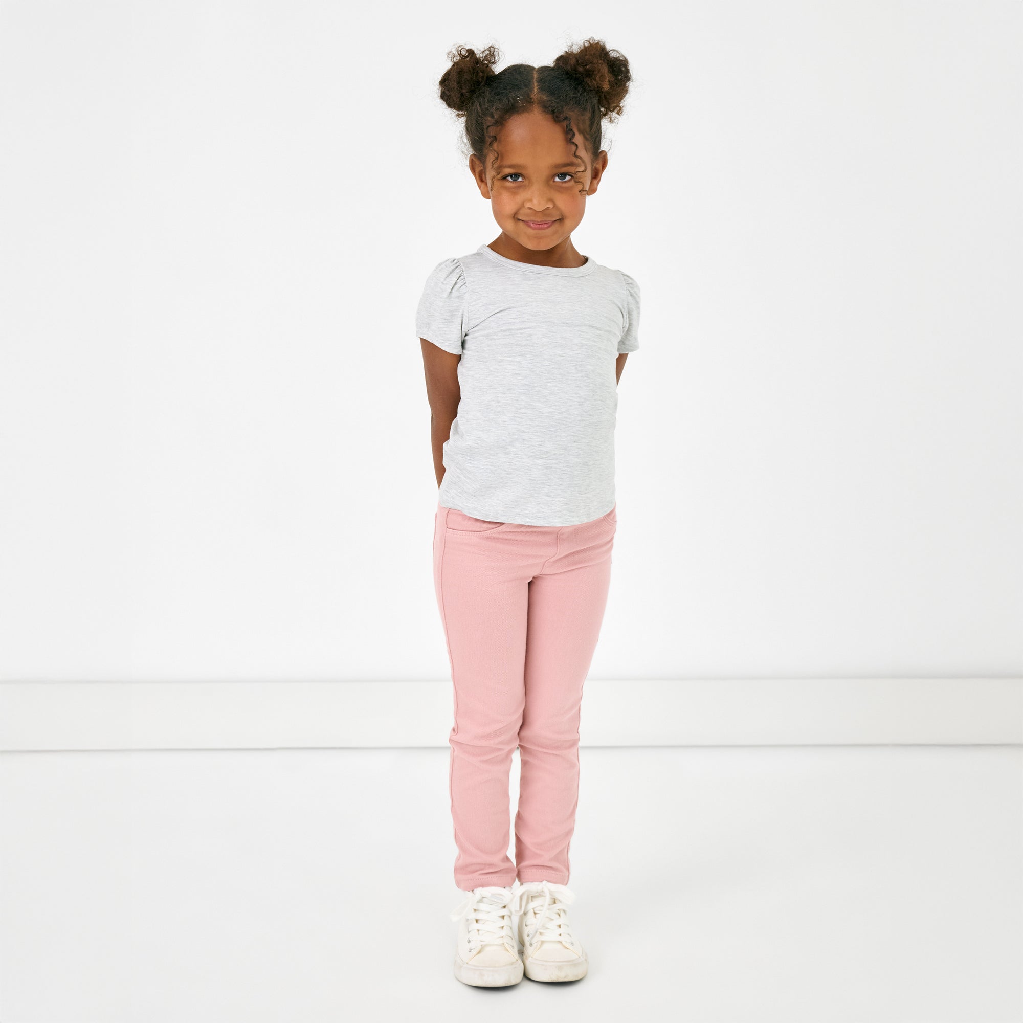 Standing child wearing the Mauve Blush Denim Jegging