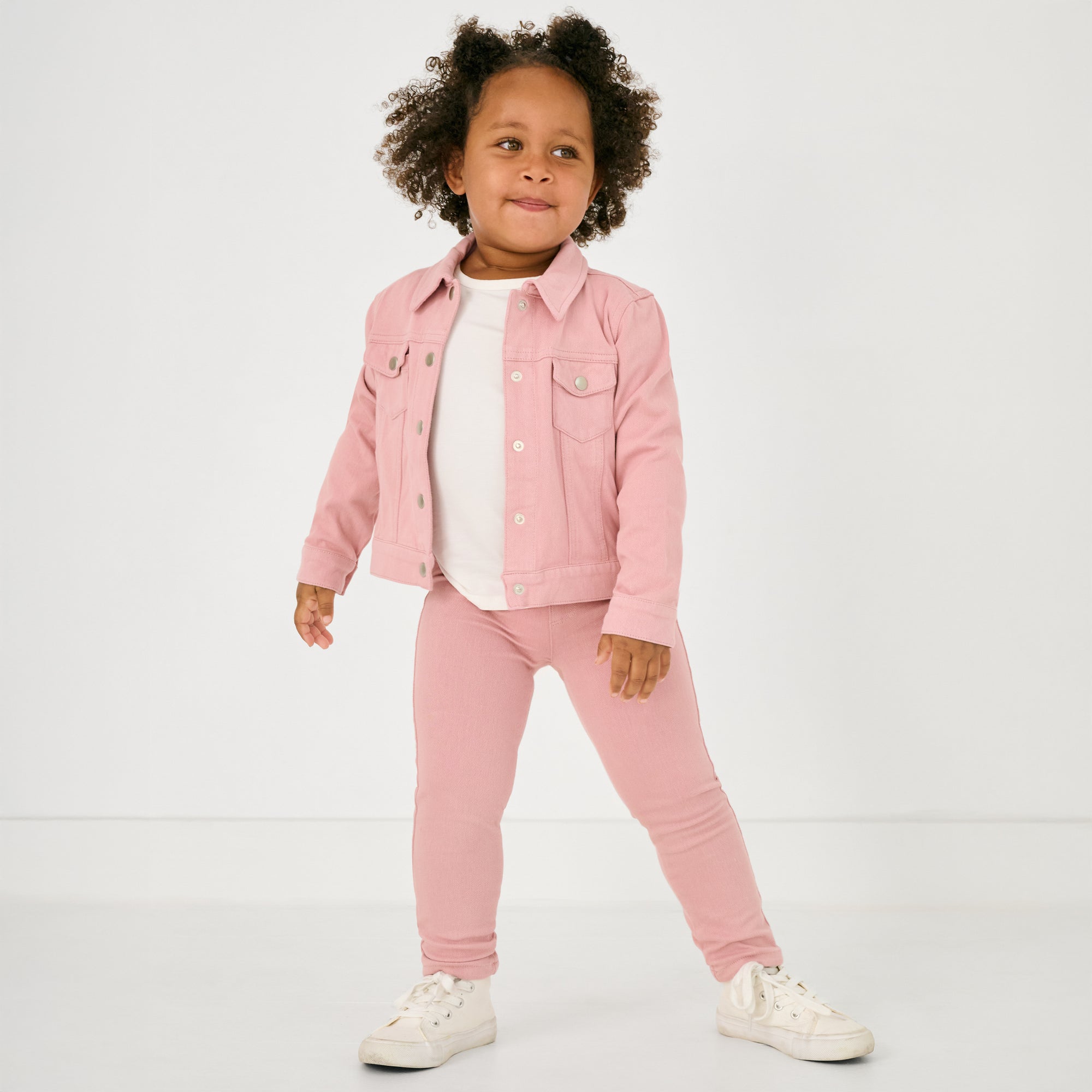 Standing child wearing the Mauve Blush Denim Jegging and matching jacket