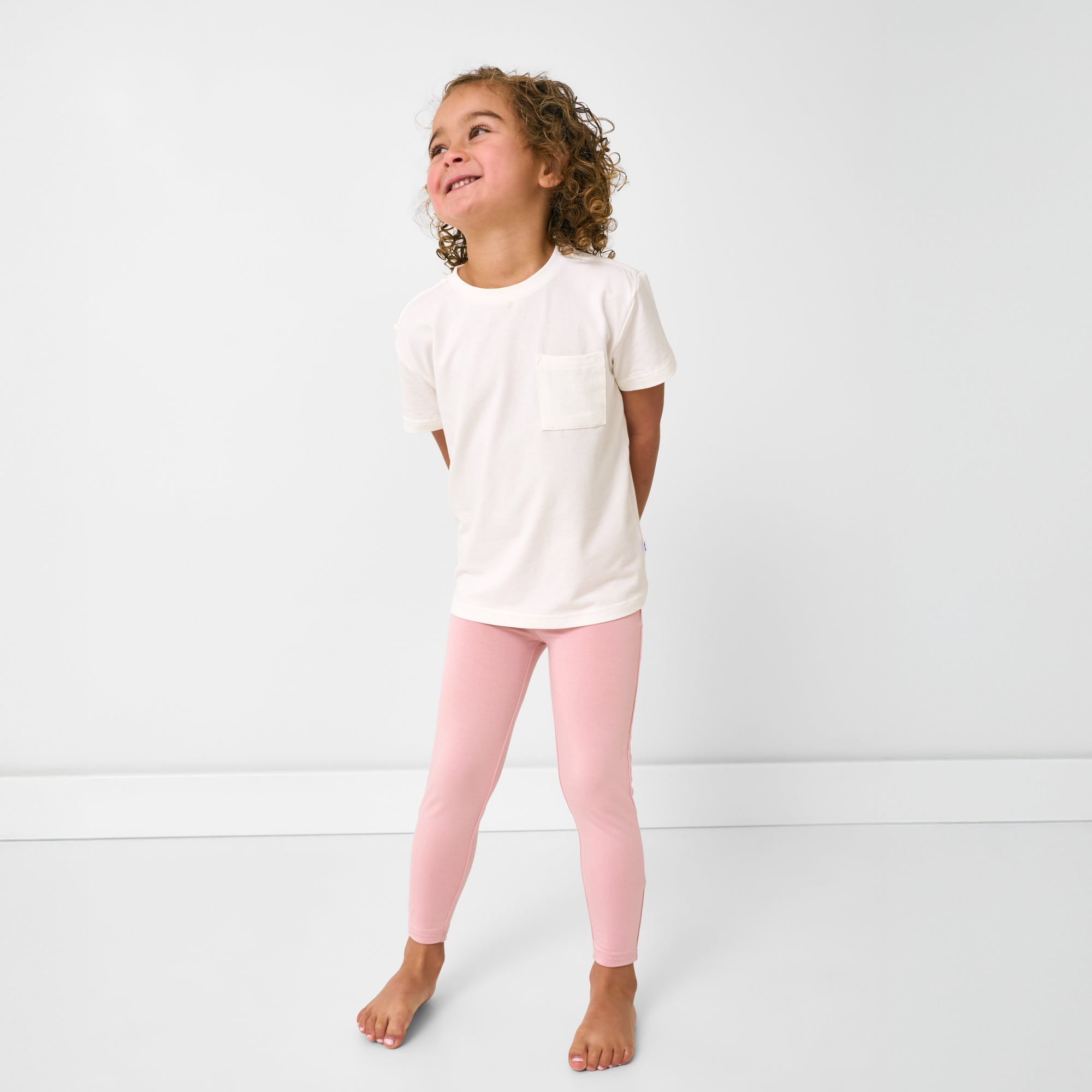 Standing child wearing the Mauve Blush Legging and white relaxed tee