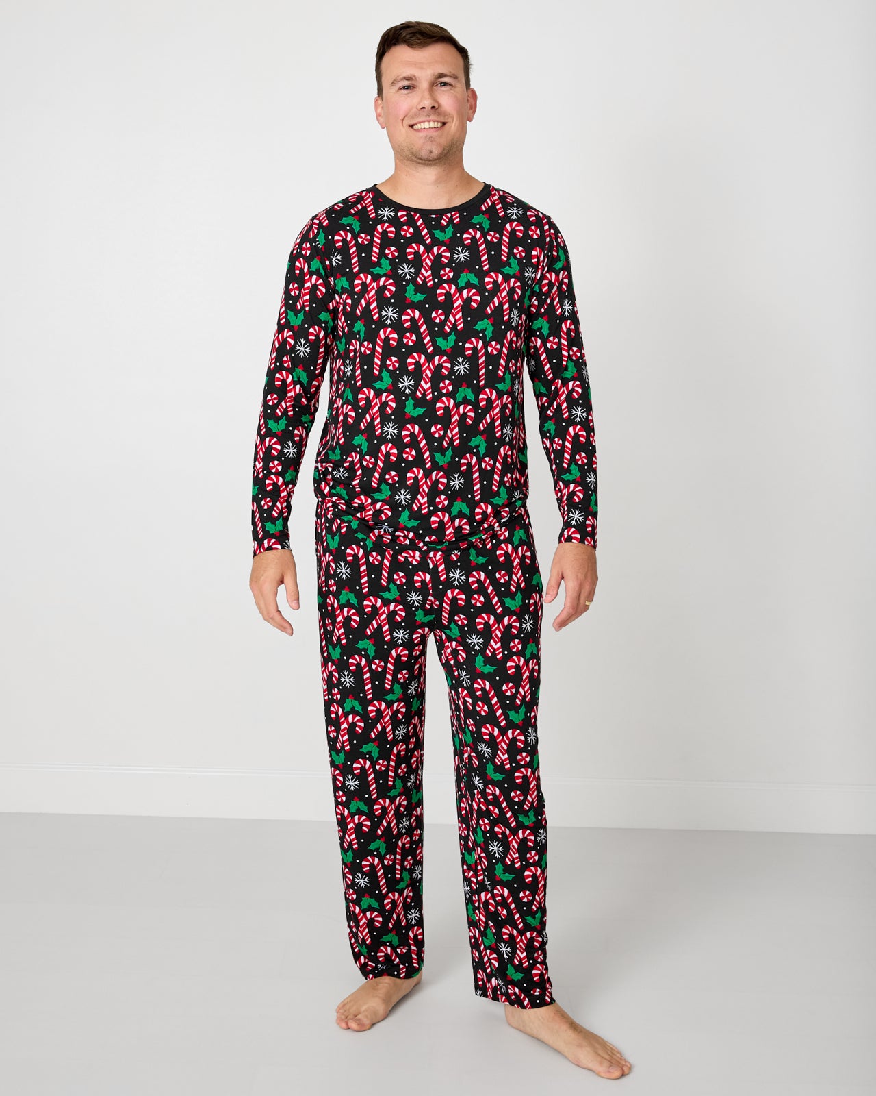 Man wearing the Merry Mints Men's Long Sleeve Pajama Top with matching pajama pants
