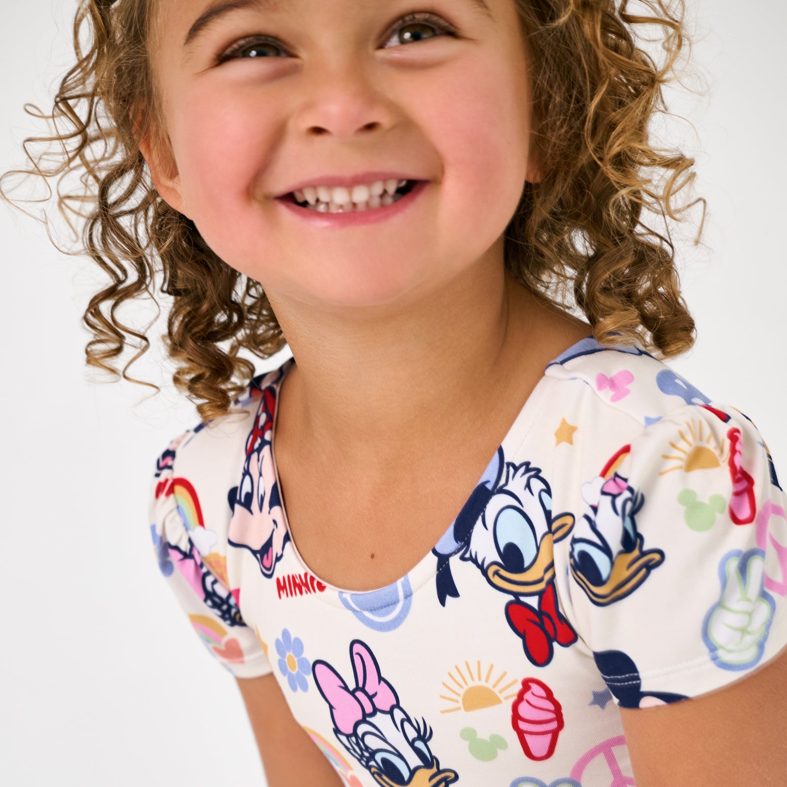 Close up of smiling girl wearing a Disney Mickey's Clubhouse themed dress