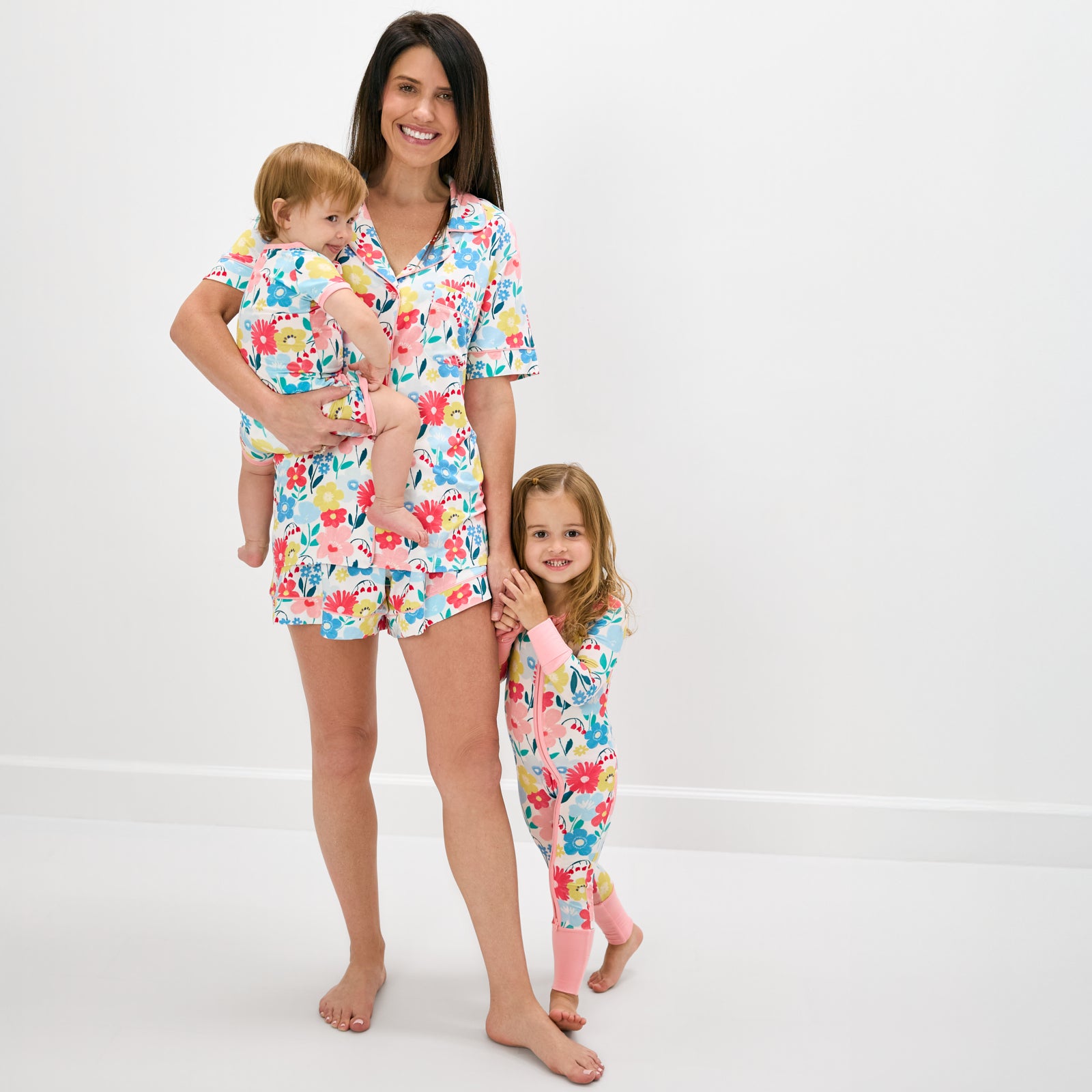 Mother and two children wearing matching floral print bamboo pajamas