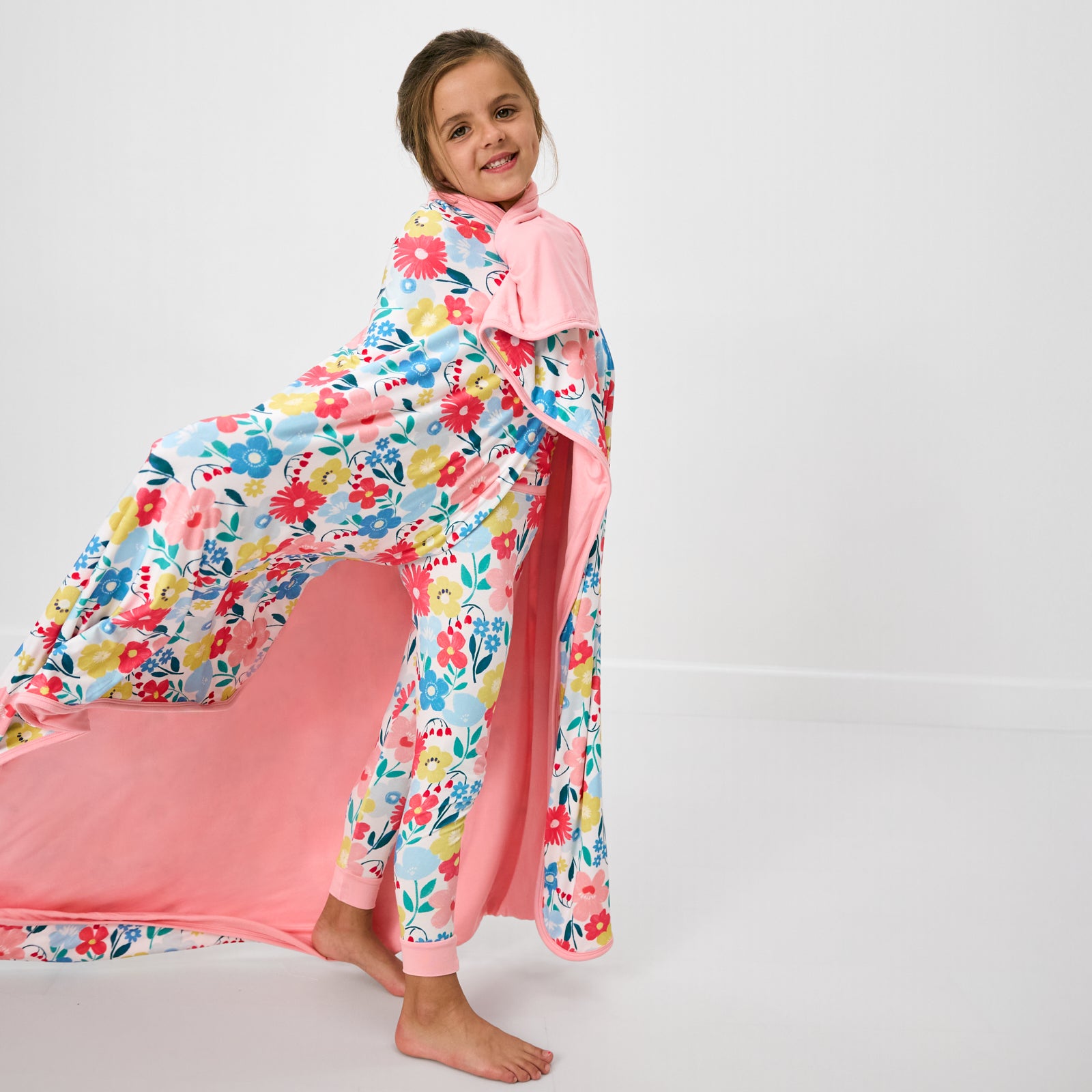 Standing girl wrapped in the Midsummer Meadow Large Cloud Blanket®