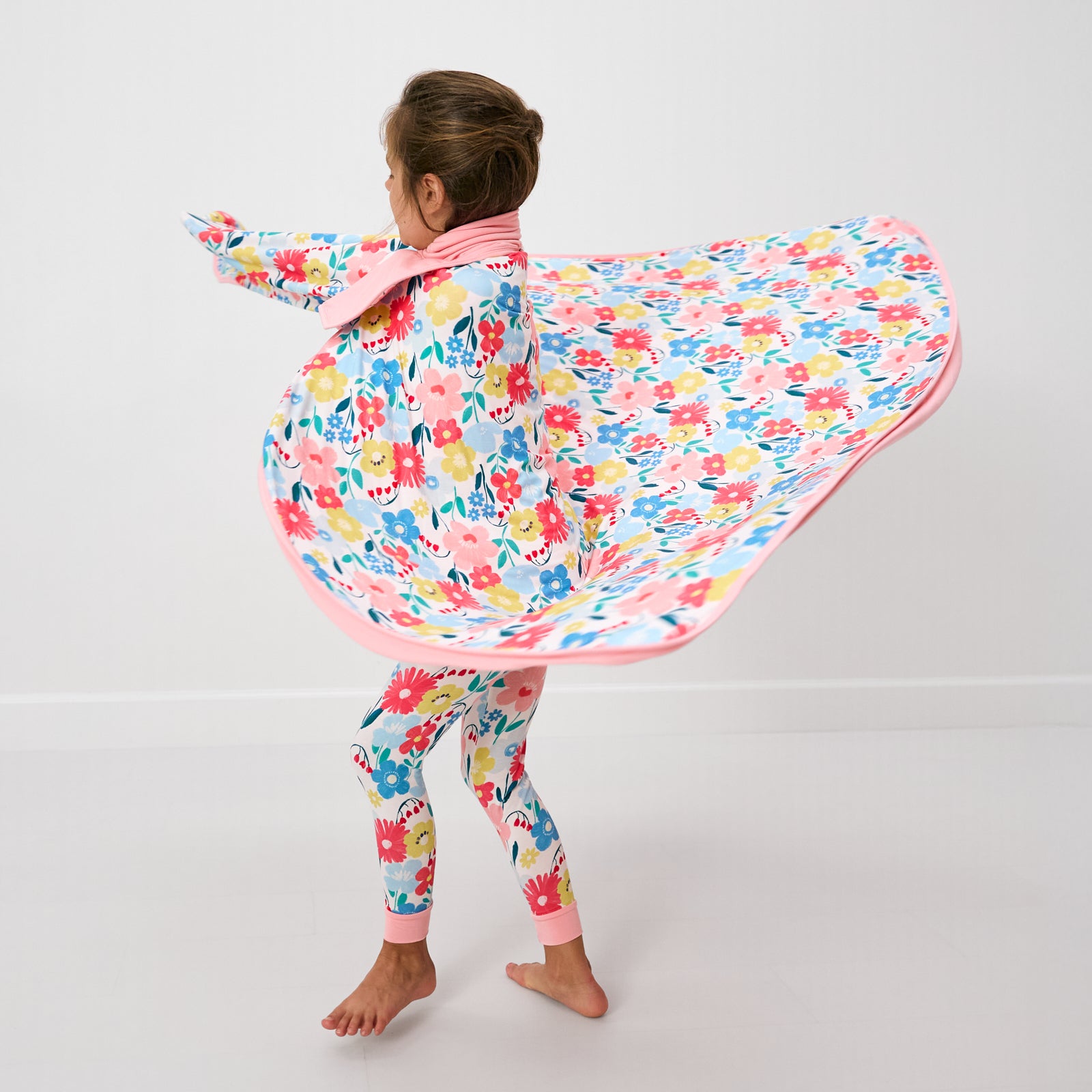 Twirling girl wearing the Midsummer Meadow Large Cloud Blanket®