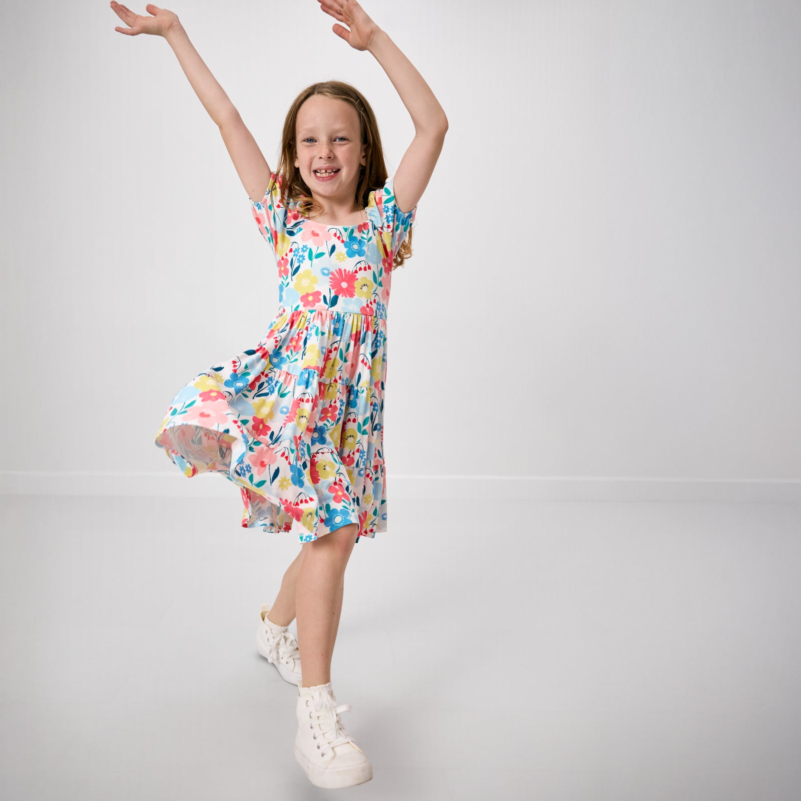 Child in motion wearing the Midsummer Meadow Peasant Dress