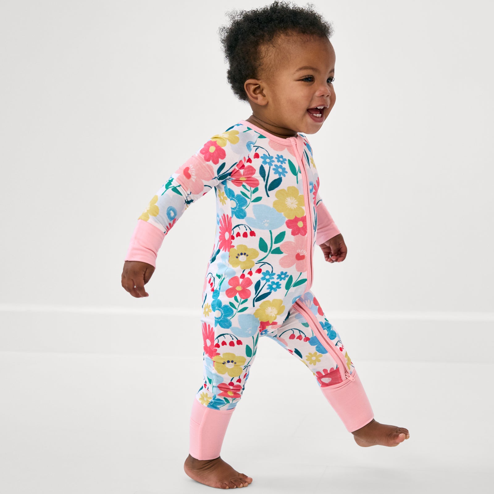 Alternate walking toddler wearing the Midsummer Meadow Zippy