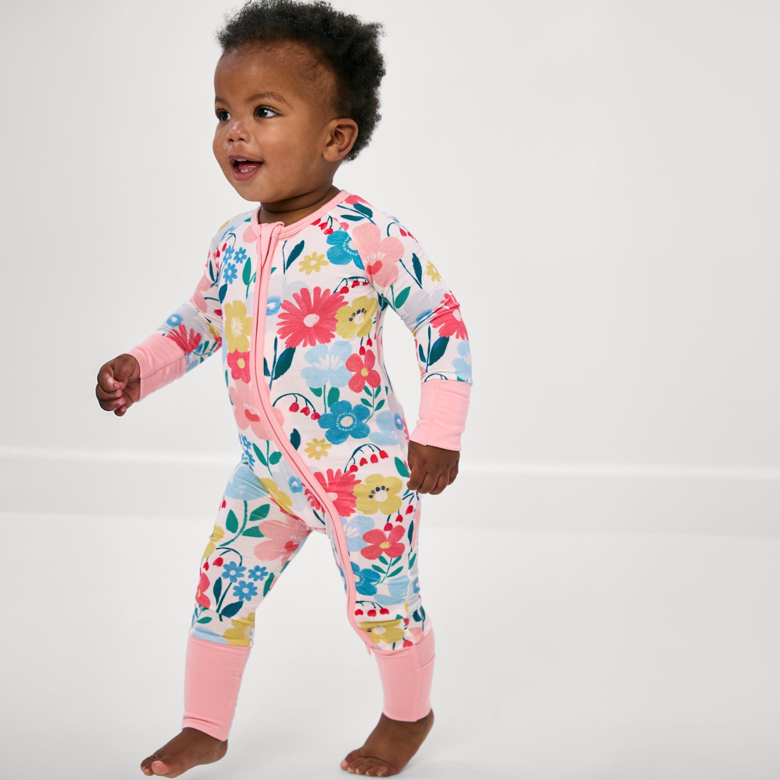 Walking toddler wearing the Midsummer Meadow Zippy