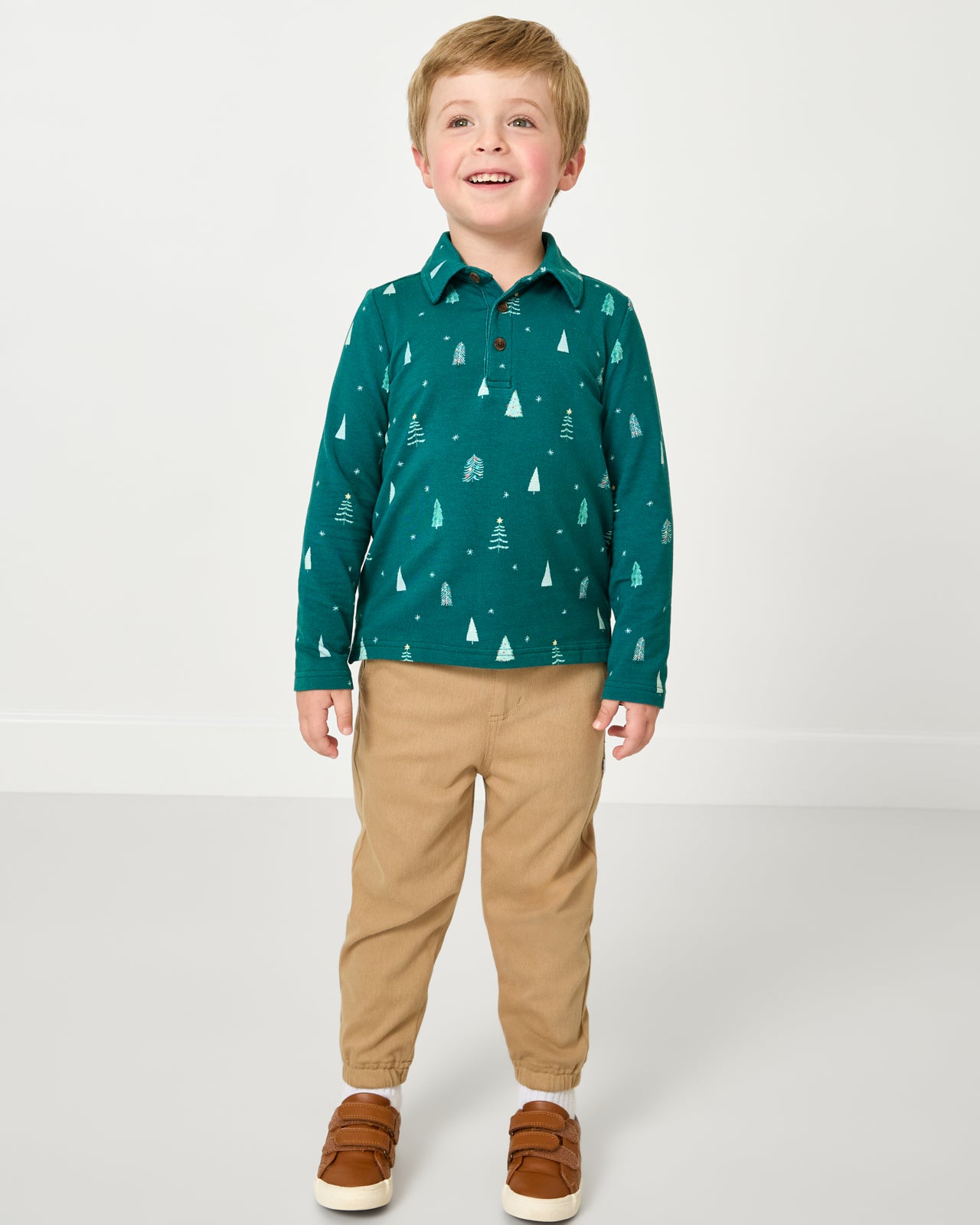 Boy wearing the Twinkling Trees Polo Shirt with khaki joggers