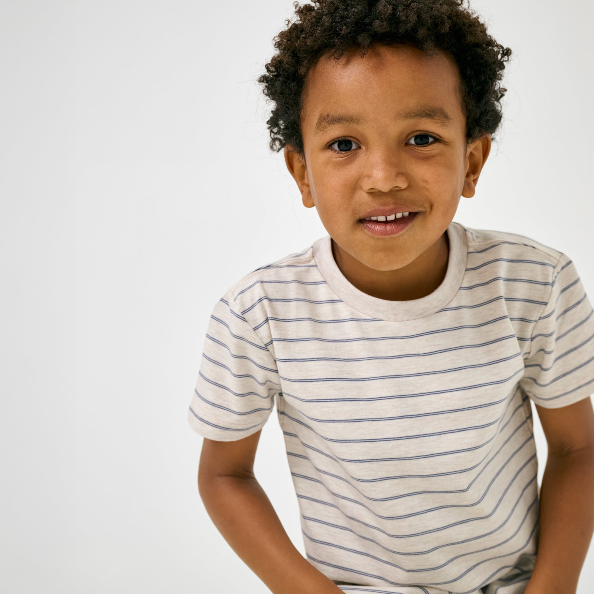 Close up of child wearing the Stone Stripes Short Sleeve Relaxed Tee