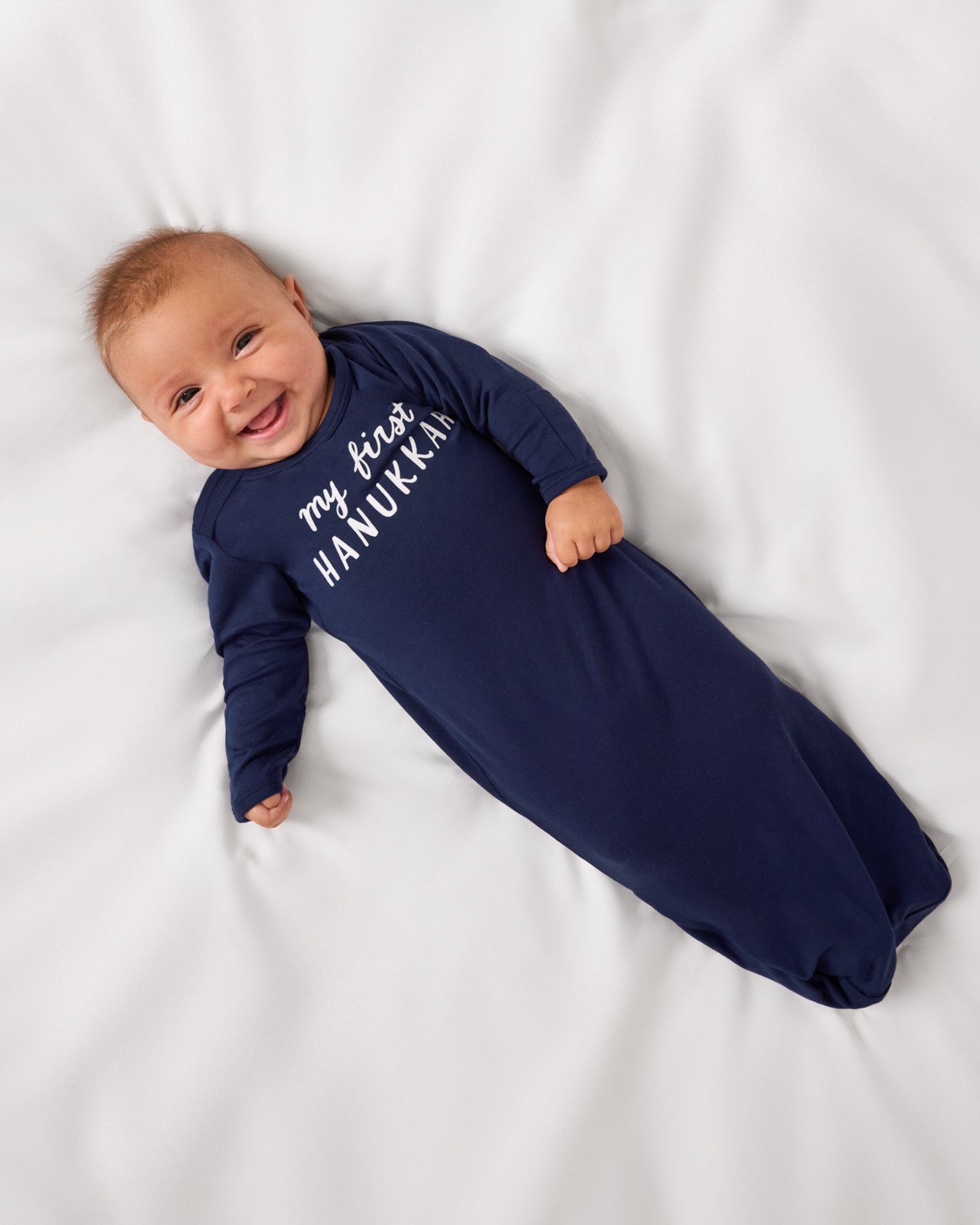 Aerial view of baby wearing the My First Hanukkah Infant Gown