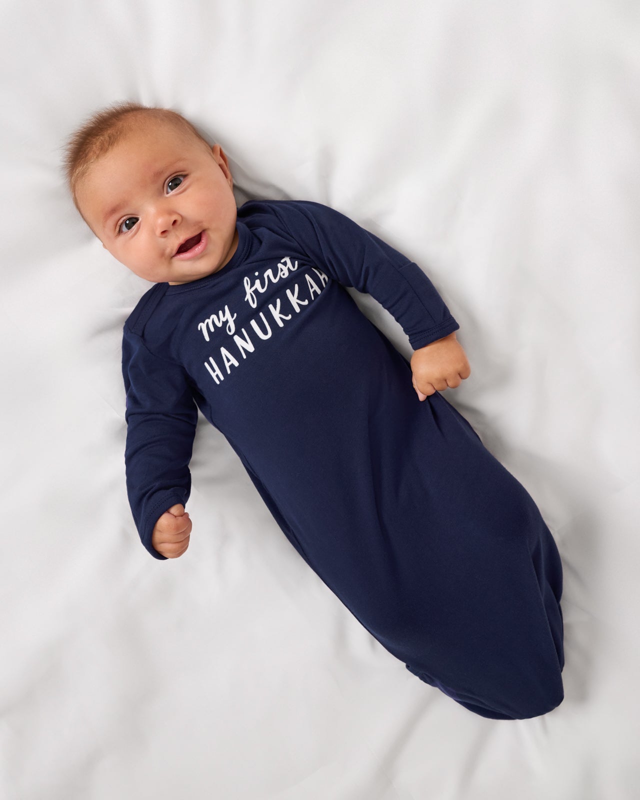 Alternate aerial view of baby wearing the My First Hanukkah Infant Gown