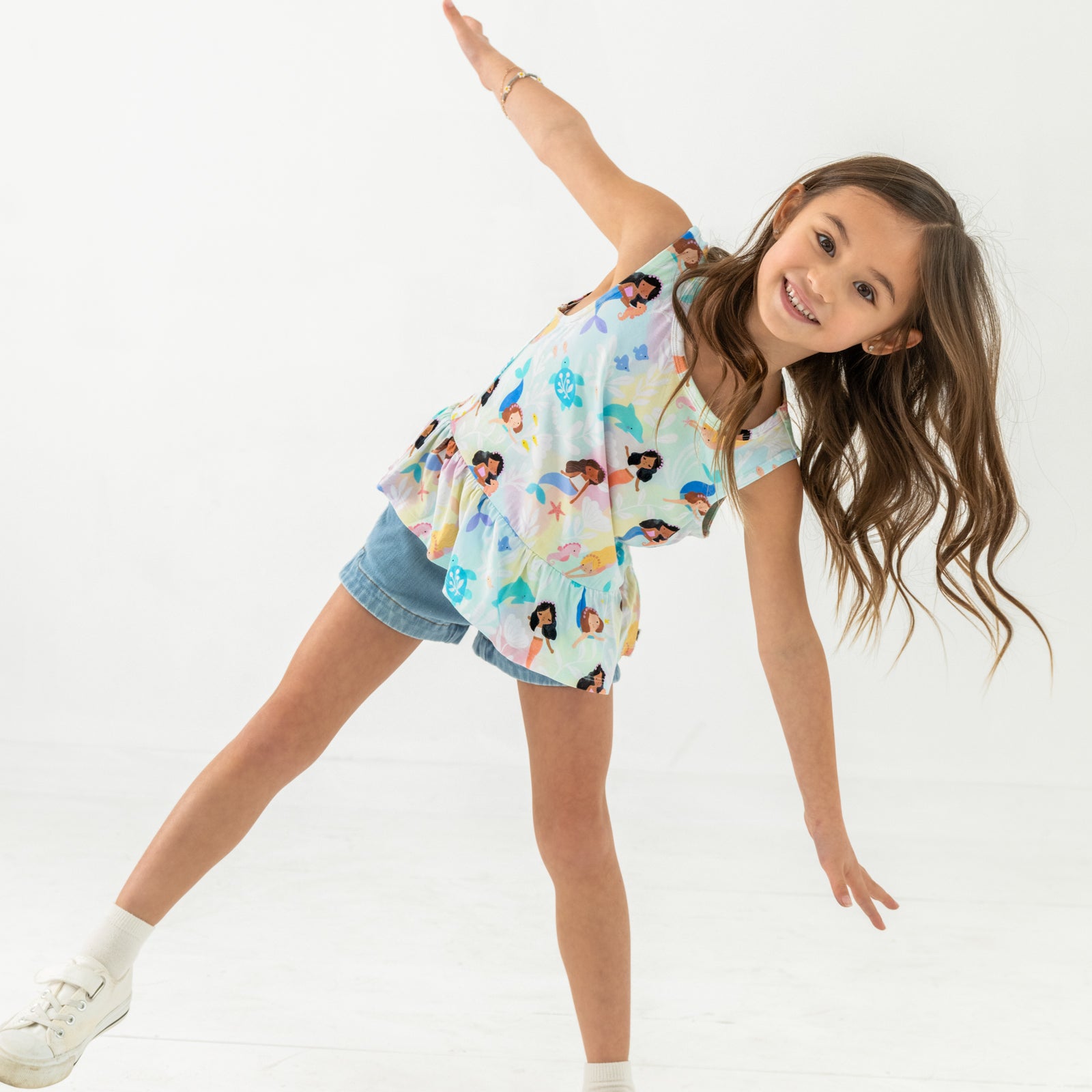 Posing child wearing the Mystic Mermaids Peplum Tank