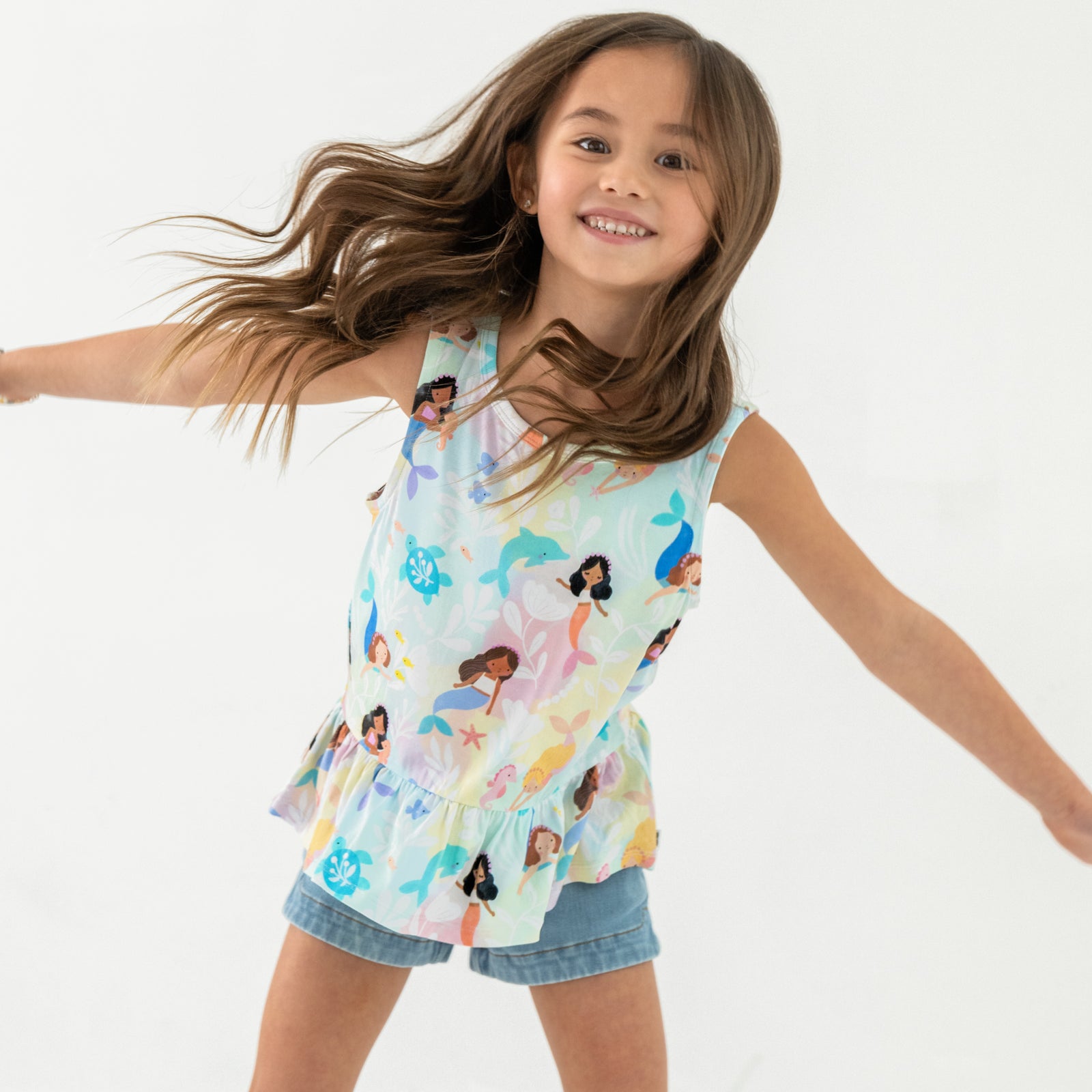 Child in motion wearing the Mystic Mermaids Peplum Tank