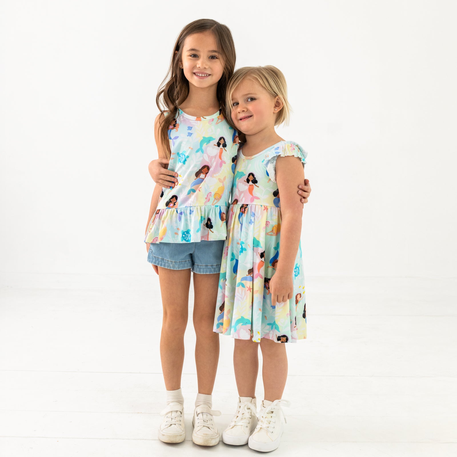 Two children wearing matching Mystic Mermaids play styles