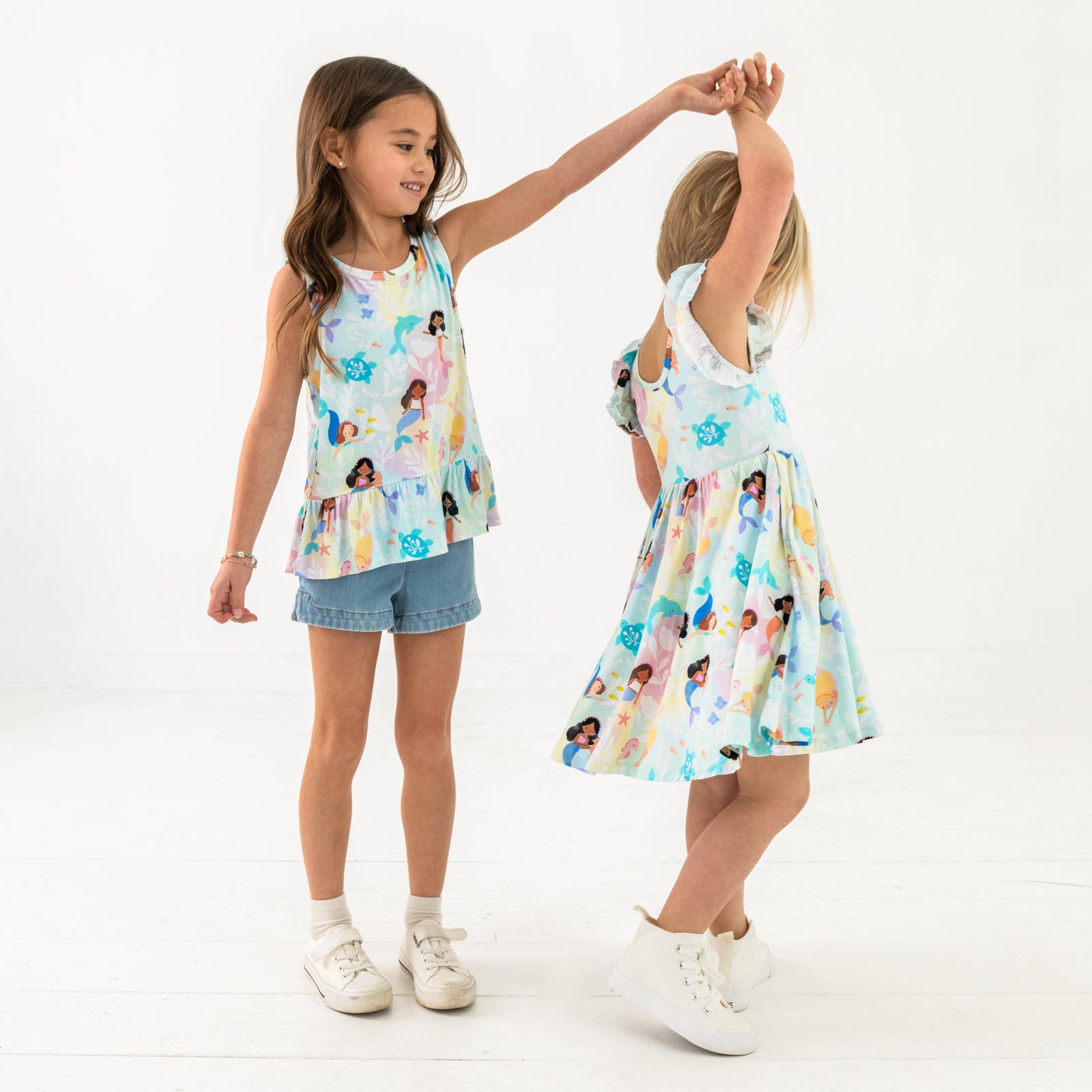 Two children wearing matching Mystic Mermaids styles