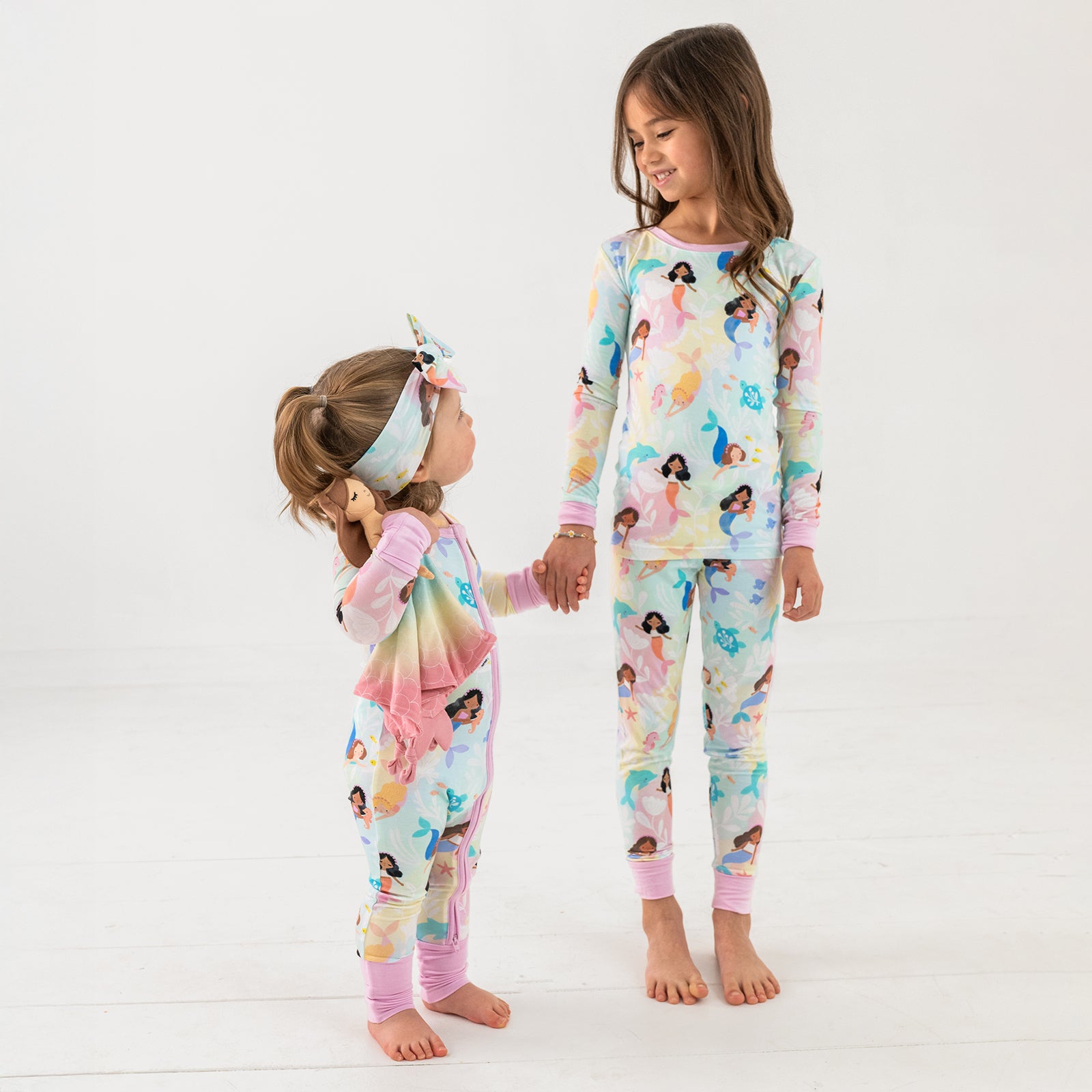 Two standing children wearing matching Mystic Mermaids bamboo pajamas